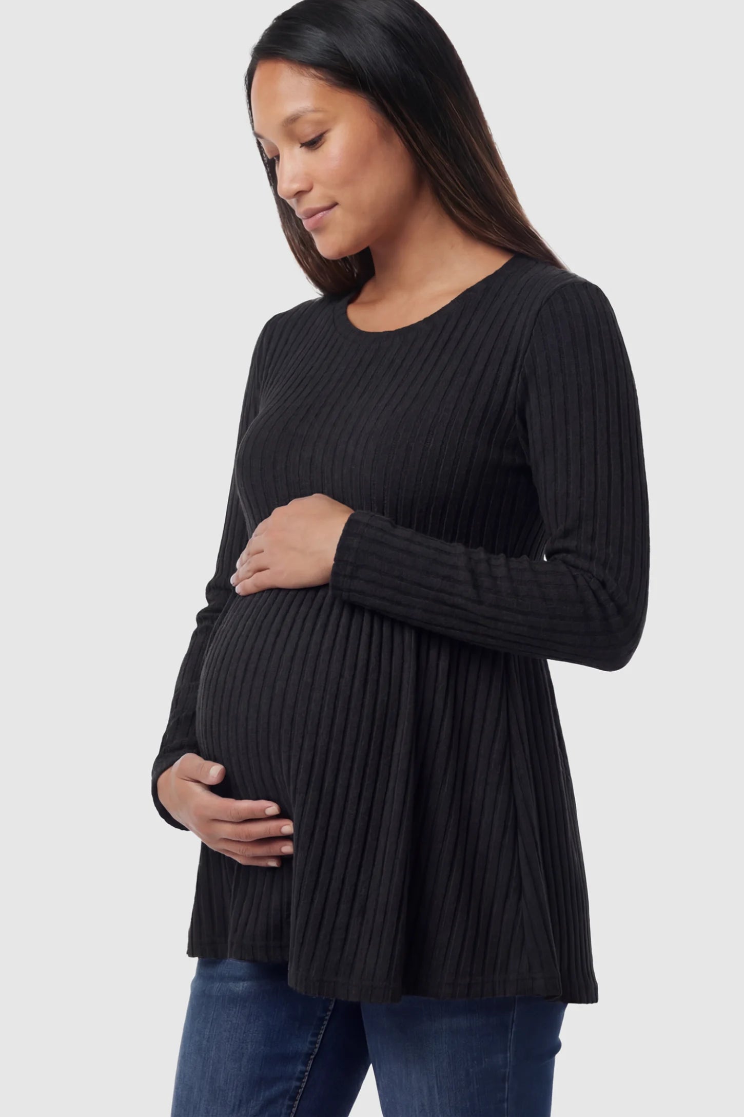 Ribbed Knit Long Sleeve Maternity Top Ribbed Knit Long Sleeve Maternity Top in black featuring an empire waist and high-stretch fabric on a pregnant model showing side.