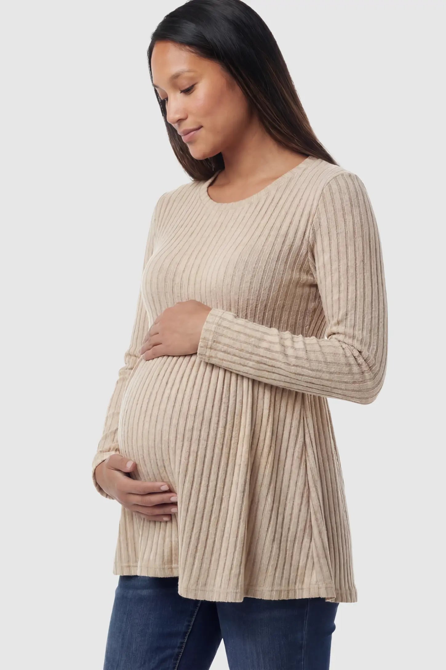 Ribbed Knit Long Sleeve Maternity Top Ribbed Knit Long Sleeve Maternity Top in Khali featuring an empire waist and high-stretch fabric on a pregnant model showing side.