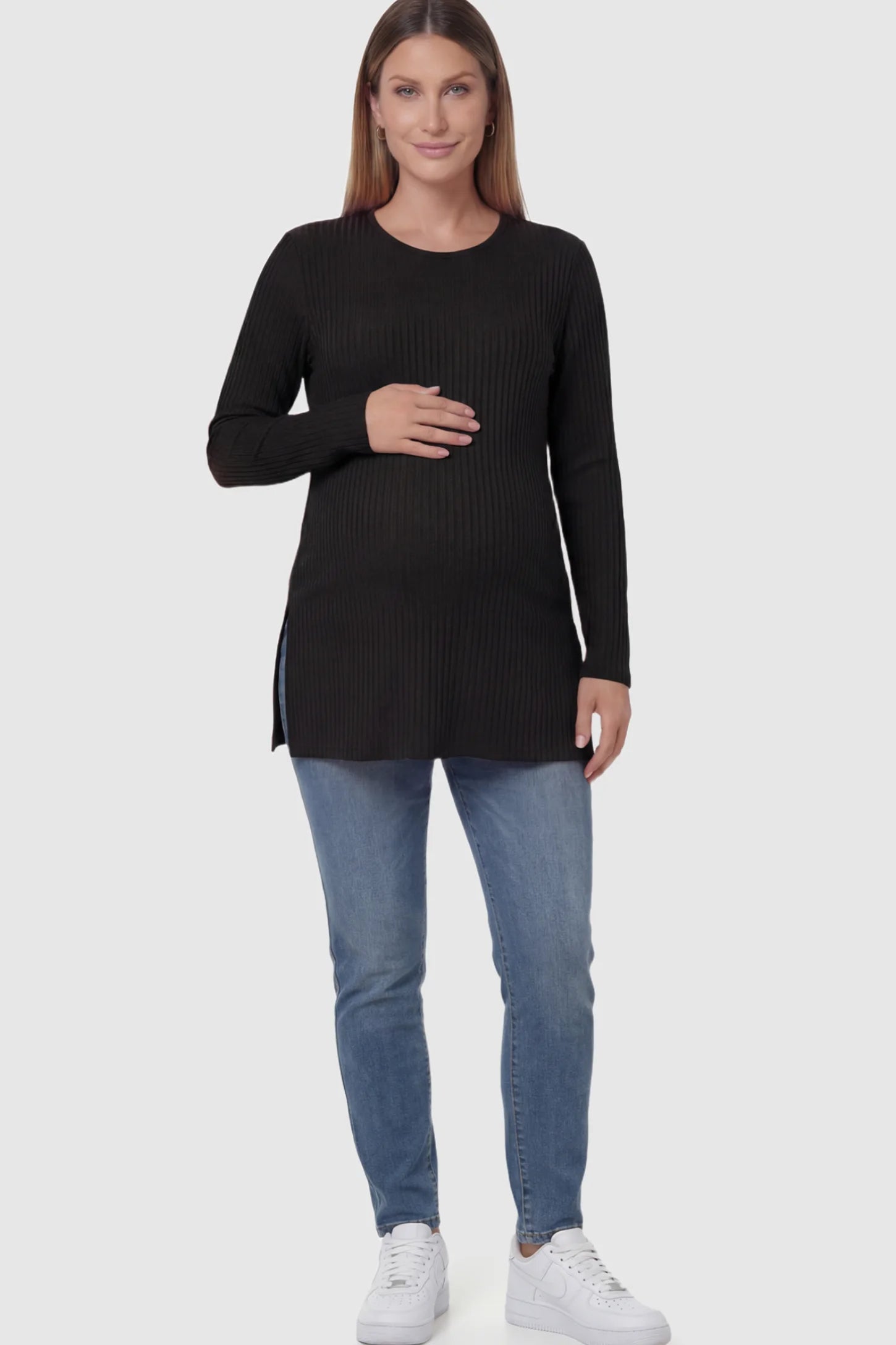Ribbed Knit Long Sleeve Side Slit Maternity Top Ribbed Knit Side Slit Maternity Top in Black featuring high-stretch fabric and tunic length on a pregnant model showing front.