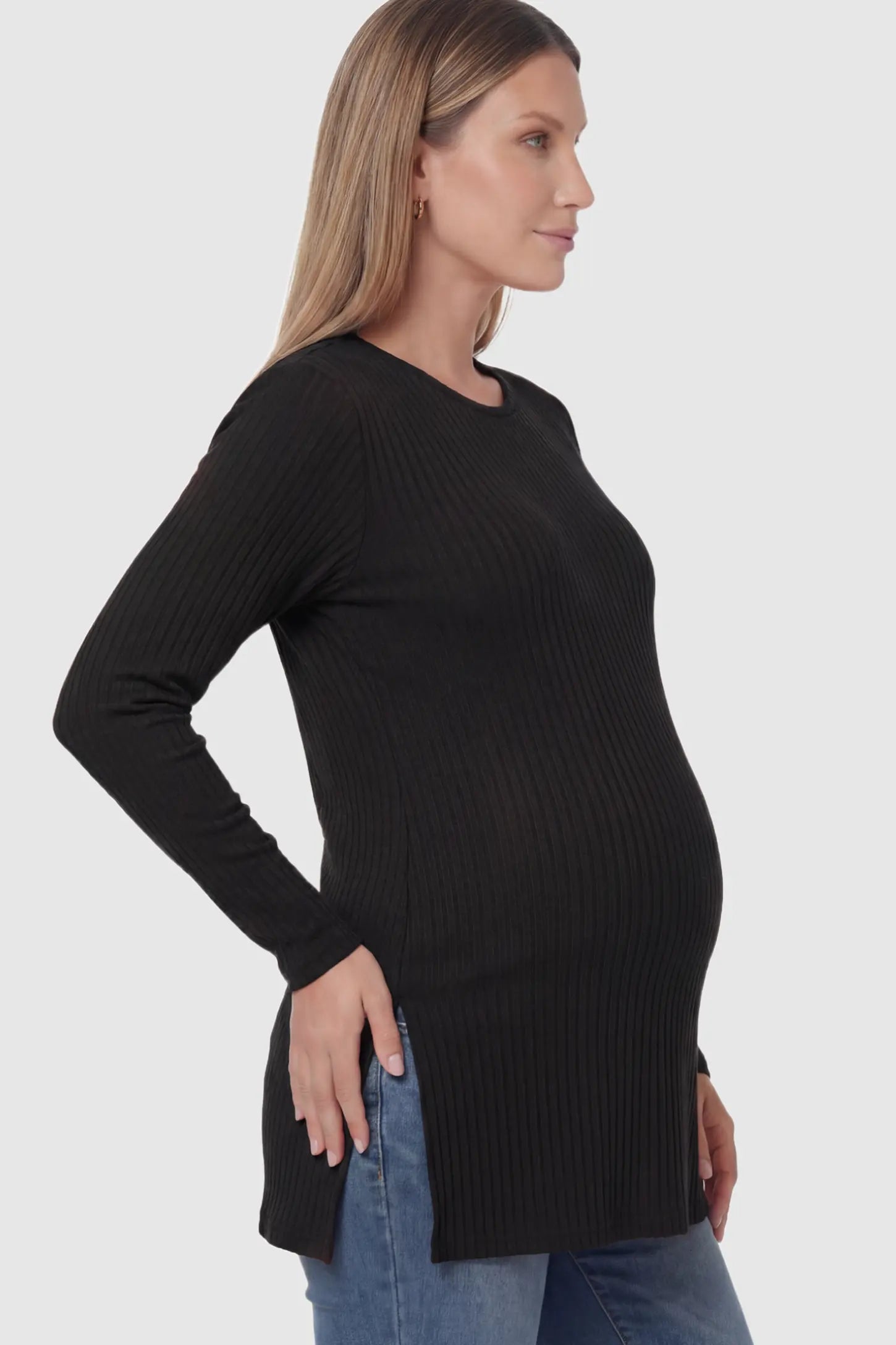 Ribbed Knit Side Slit Maternity Top in Black featuring high-stretch fabric and tunic length on a pregnant model showing side.