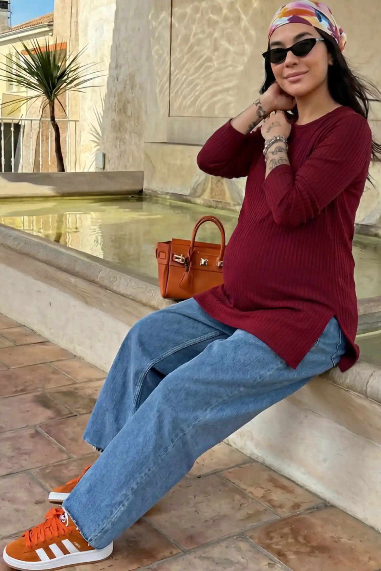 Ribbed Knit Long Sleeve Side Slit Maternity Top Ribbed Knit Side Slit Maternity Top in Burgundy featuring high-stretch fabric and tunic length on a pregnant woman.