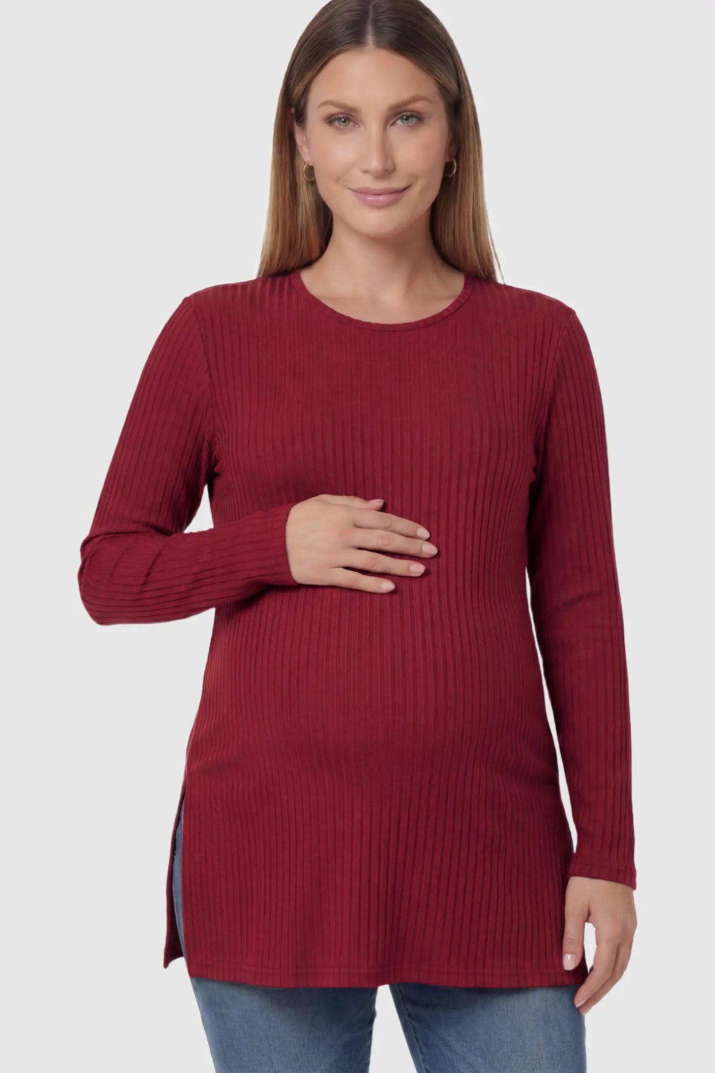 Ribbed Knit Long Sleeve Side Slit Maternity Top Ribbed Knit Side Slit Maternity Top in Burgundy featuring high-stretch fabric and tunic length on a pregnant model posing front.
