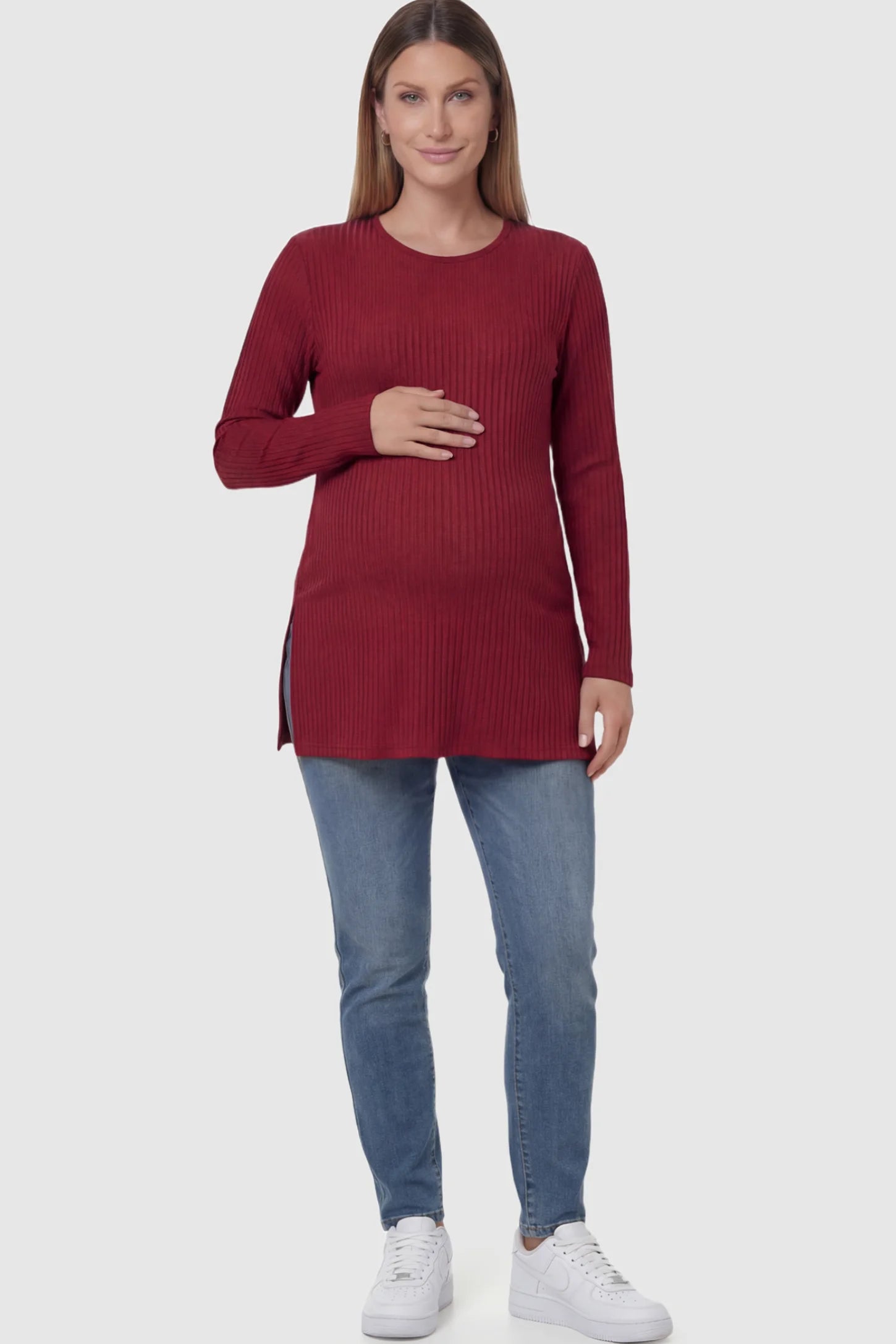 Ribbed Knit Long Sleeve Side Slit Maternity Top Ribbed Knit Side Slit Maternity Top in Burgundy featuring high-stretch fabric and tunic length on a pregnant model showing front.