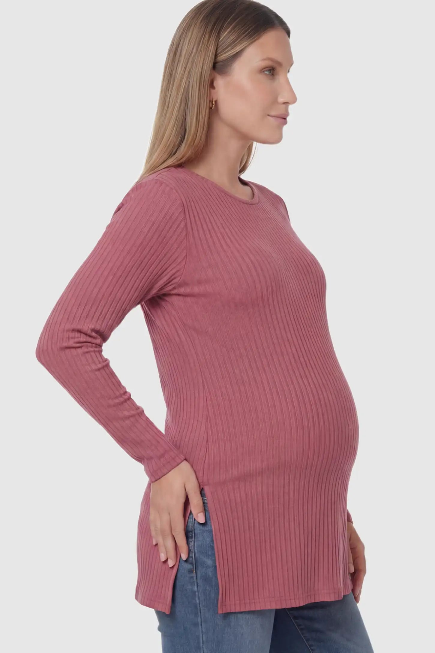 Ribbed Knit Long Sleeve Side Slit Maternity Top Ribbed Knit Side Slit Maternity Top in Pink featuring high-stretch fabric and tunic length on a pregnant model showing side.