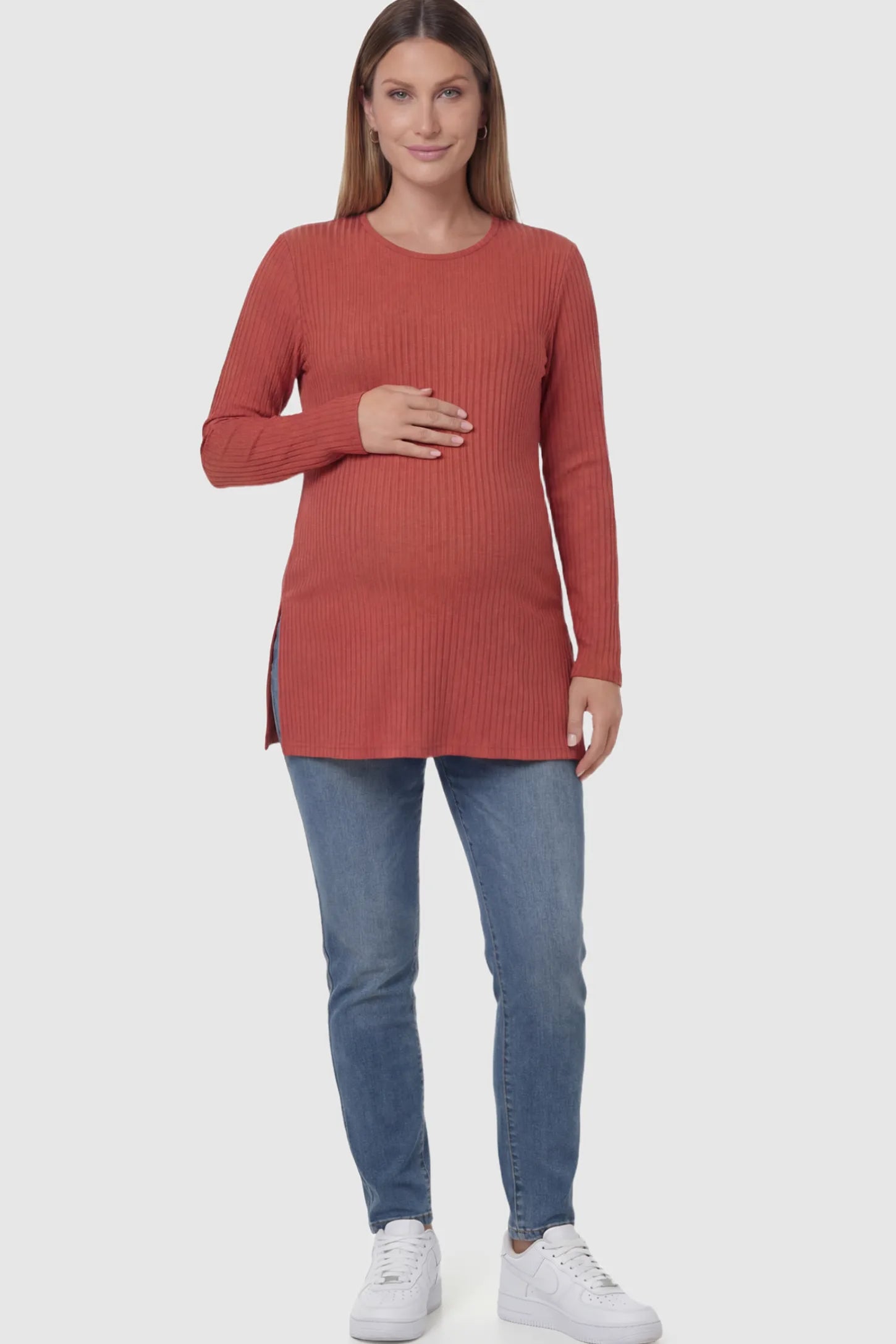 Ribbed Knit Long Sleeve Side Slit Maternity Top Ribbed Knit Side Slit Maternity Top in Red featuring high-stretch fabric and tunic length on a pregnant model showing front.