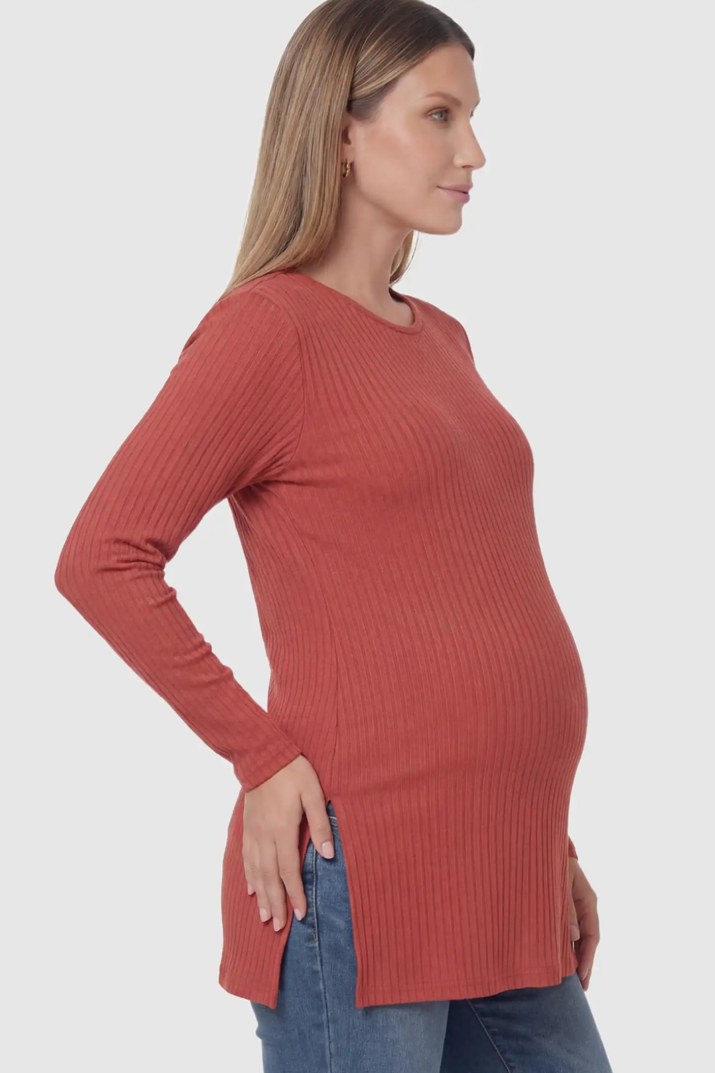 Ribbed Knit Long Sleeve Side Slit Maternity Top Ribbed Knit Side Slit Maternity Top in Red featuring high-stretch fabric and tunic length on a pregnant model showing side.