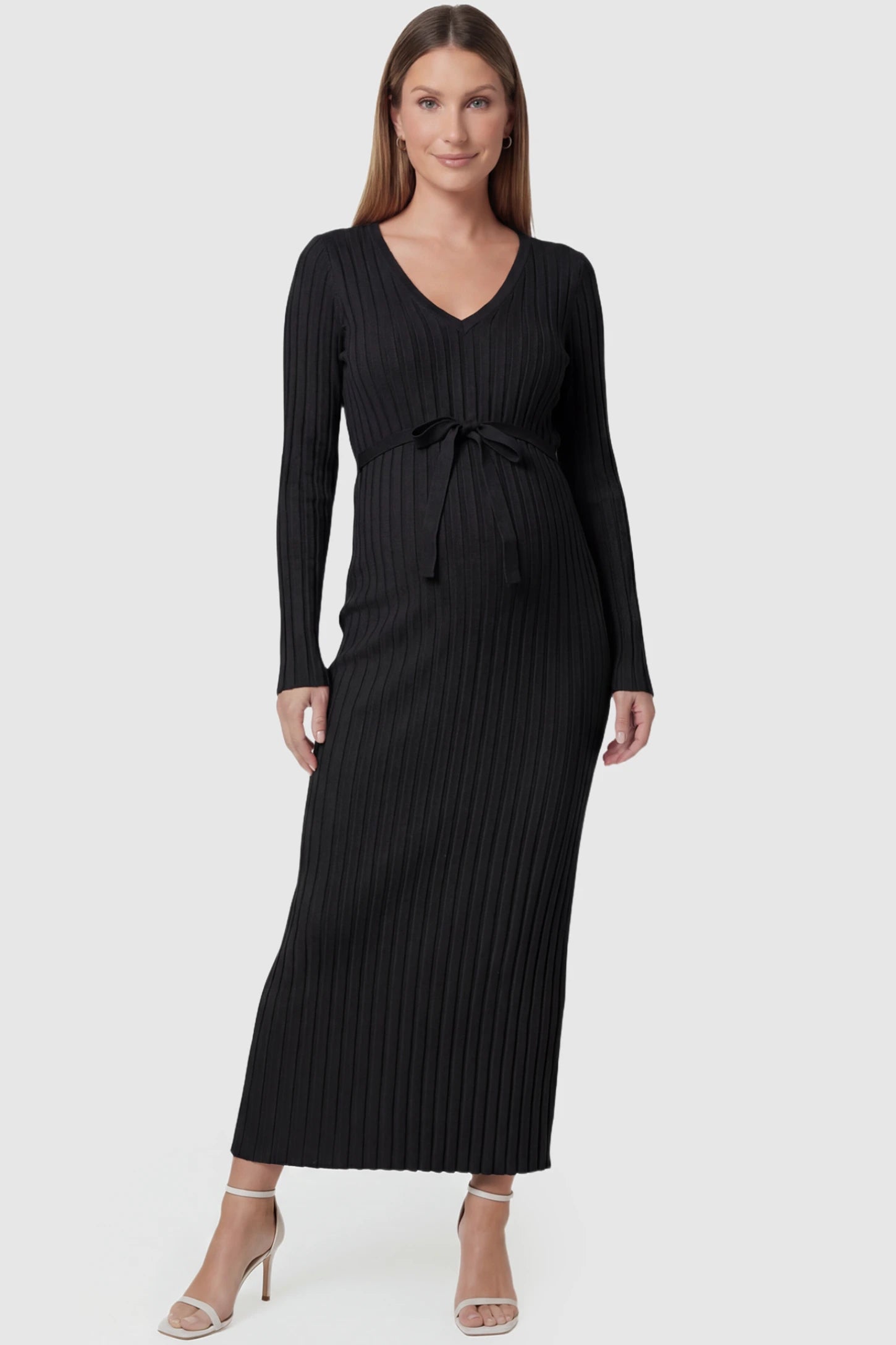 Ribbed Knit V-Neck Tie Waist Maternity Maxi Dress Ribbed Knit V-Neck Maternity Maxi Dress in Black featuring a tie waist and long sleeves on a pregnant model, front view.