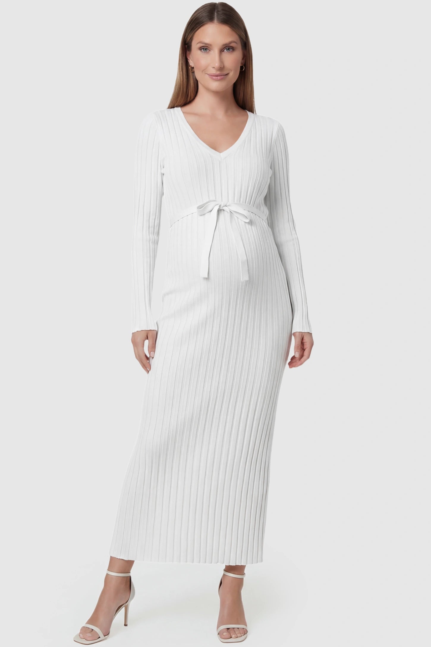 Ribbed Knit V-Neck Tie Waist Maternity Maxi Dress Ribbed Knit V-Neck Maternity Maxi Dress in White featuring a tie waist and long sleeves on a pregnant model, front view.