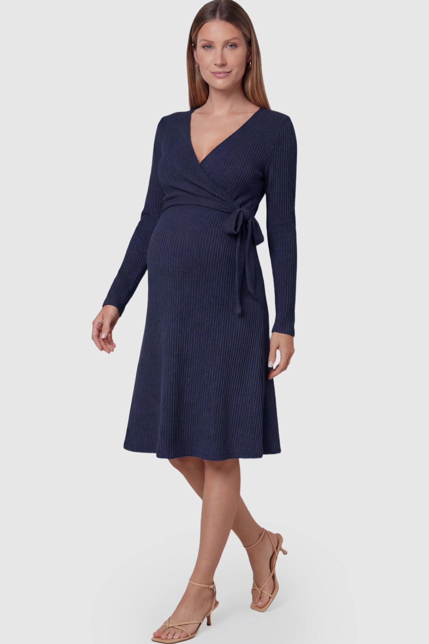 Ribbed Knit Wrap-Front Long Sleeve Maternity & Nursing Midi Dress in Dark Blue featuring a side-tie on a pregnant model.