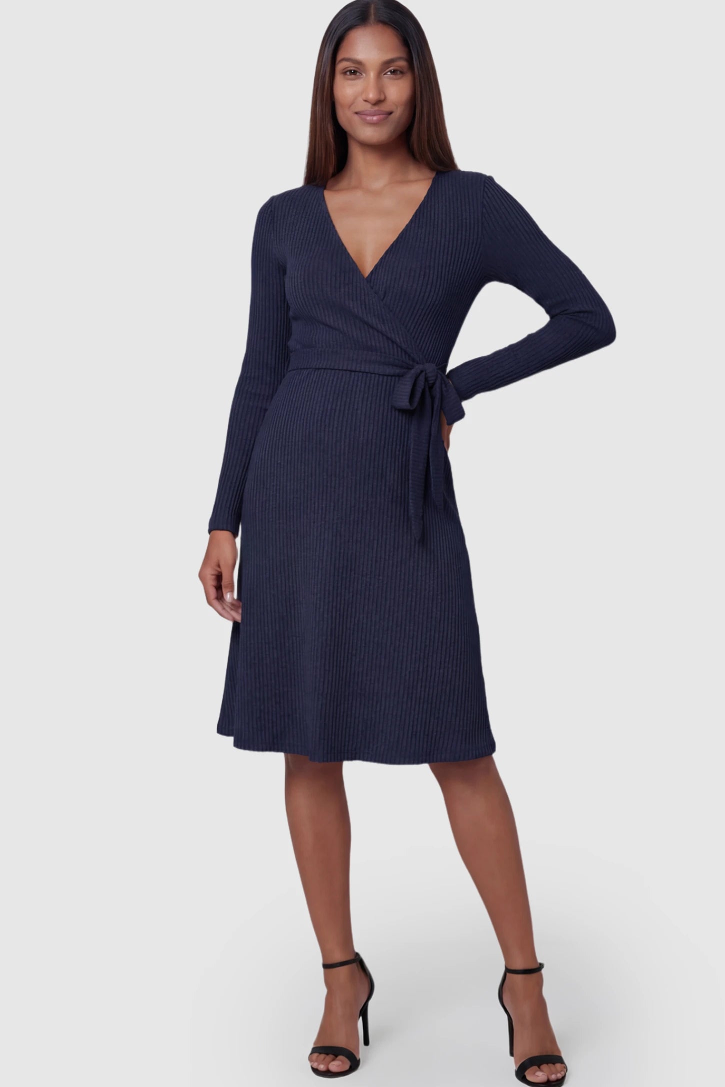 Ribbed Knit Wrap-Front Long Sleeve Maternity & Nursing Dress Ribbed Knit Wrap-Front Long Sleeve Maternity & Nursing Midi Dress in Dark Blue featuring a side-tie on a postpartum model.