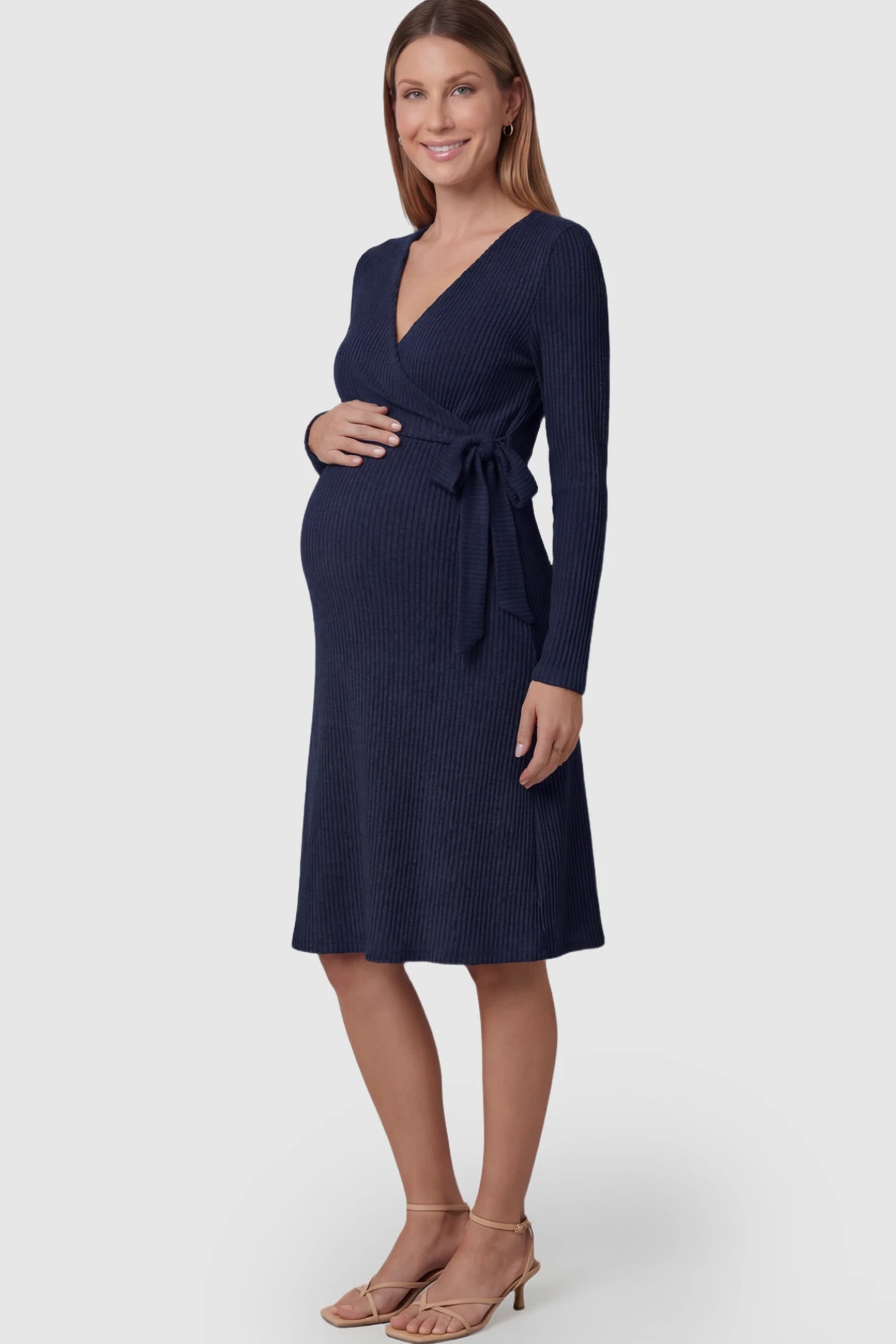 Ribbed Knit Wrap-Front Long Sleeve Maternity & Nursing Midi Dress in Dark Blue featuring a side-tie on a pregnant model.
