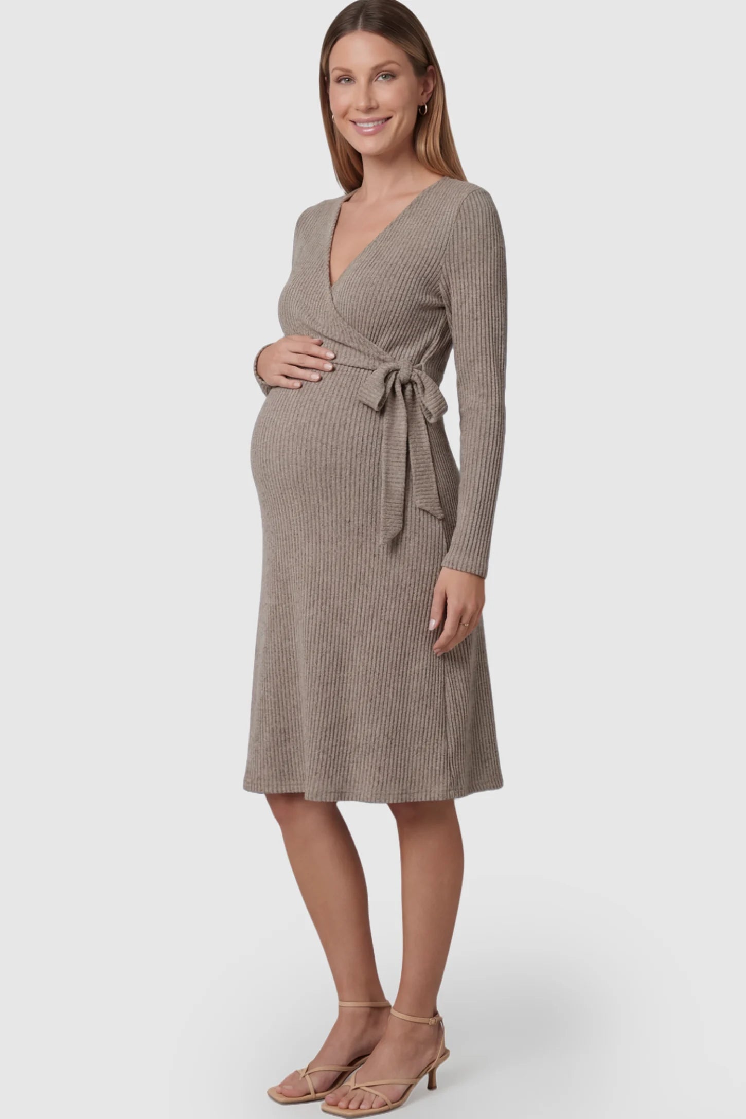 Ribbed Knit Wrap-Front Long Sleeve Maternity & Nursing Dress Ribbed Knit Wrap-Front Long Sleeve Maternity & Nursing Midi Dress in Khaki featuring a side-tie on a pregnant model.