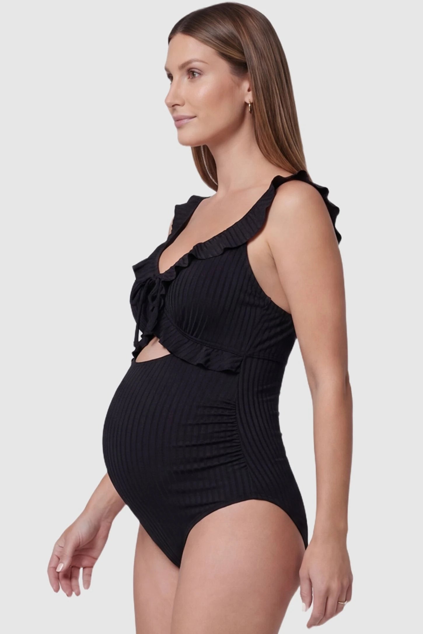 Ribbed Lace-Up Back Maternity One-Piece Side view of the Ribbed Lace-Up Back Maternity One-Piece in Black showing side-seam ruching on a pregnant model.