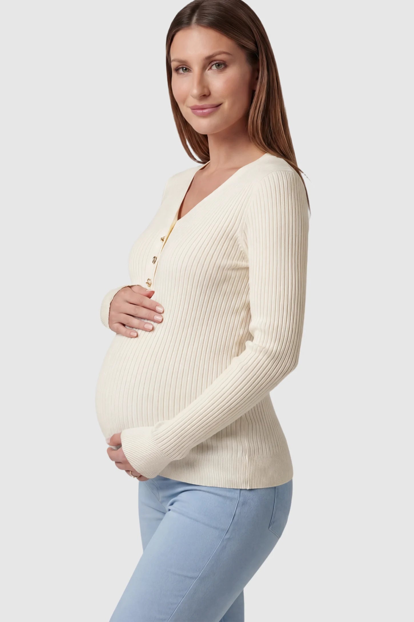 Ribbed Maternity Henley Top in Apricot featuring a functional button placket and vertical rib knit on a pregnant model showing side.