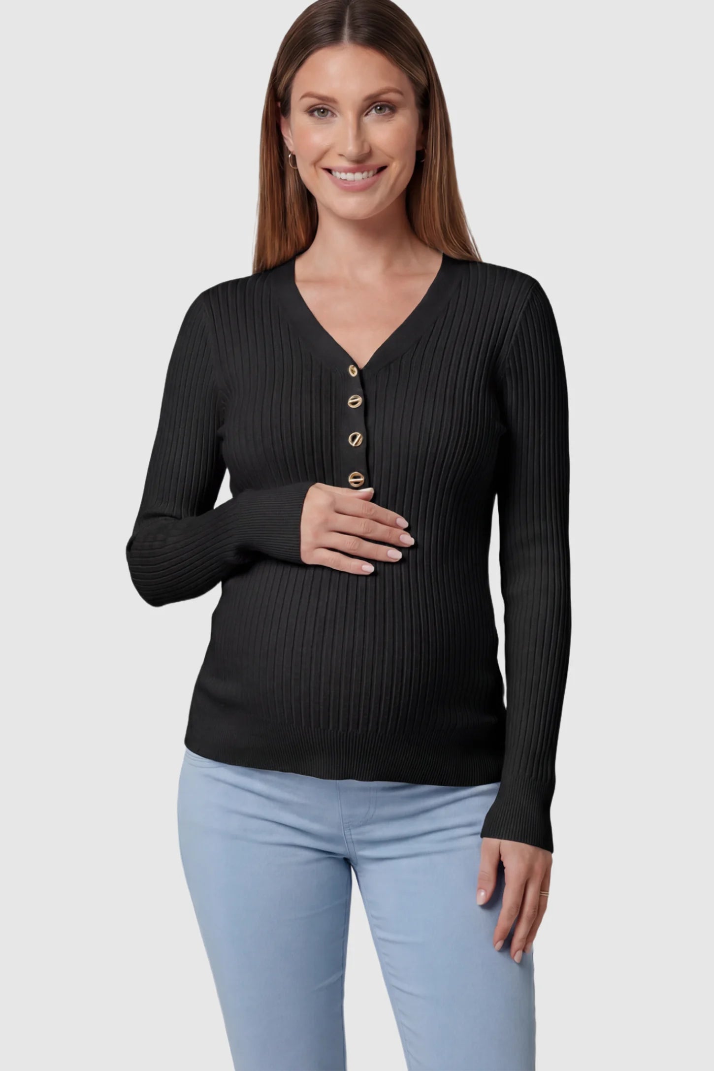 Ribbed Long Sleeve Maternity Henley Top Ribbed Maternity Henley Top in Black featuring a functional button placket and vertical rib knit on a pregnant model showing front.