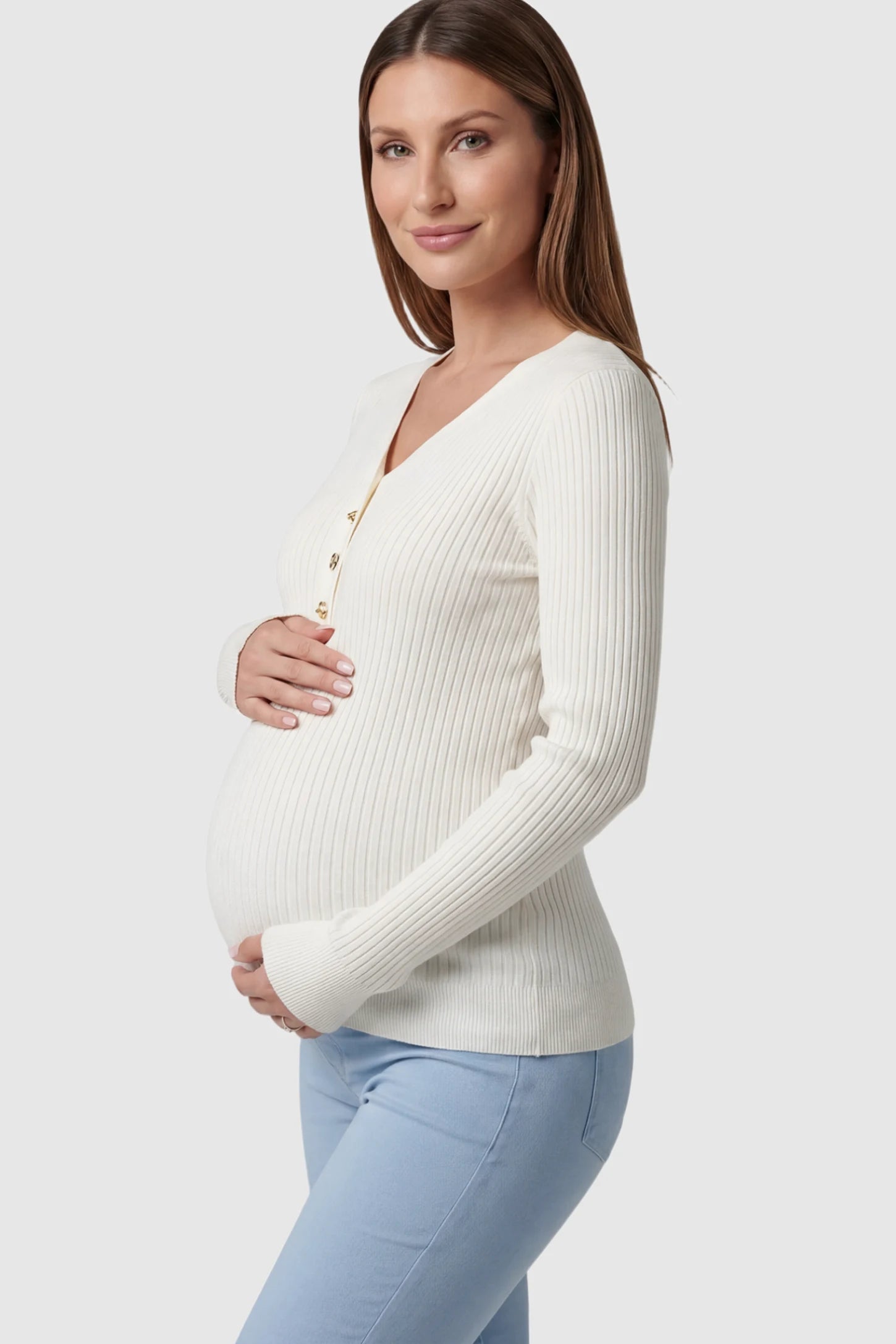 Ribbed Long Sleeve Maternity Henley Top Ribbed Maternity Henley Top in Off White featuring a functional button placket and vertical rib knit on a pregnant model showing side.