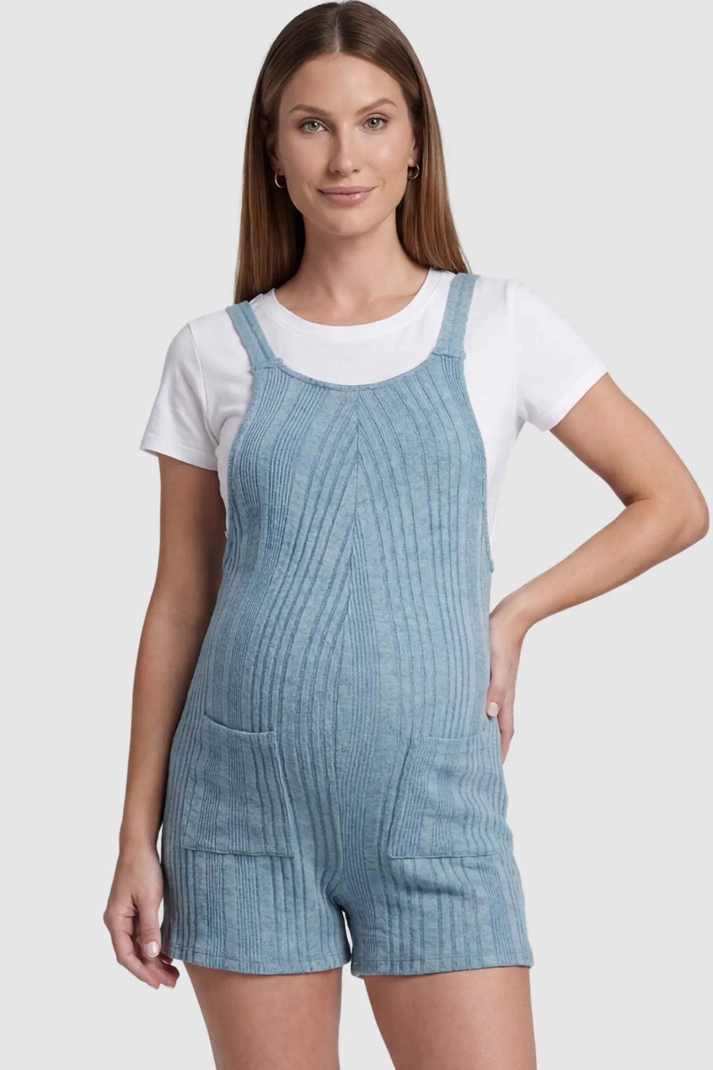 Ribbed Pocket Knit Maternity Romper Ribbed Pocket Knit Romper in Blue featuring a classic vertical ribbed texture on a pregnant model, front view.