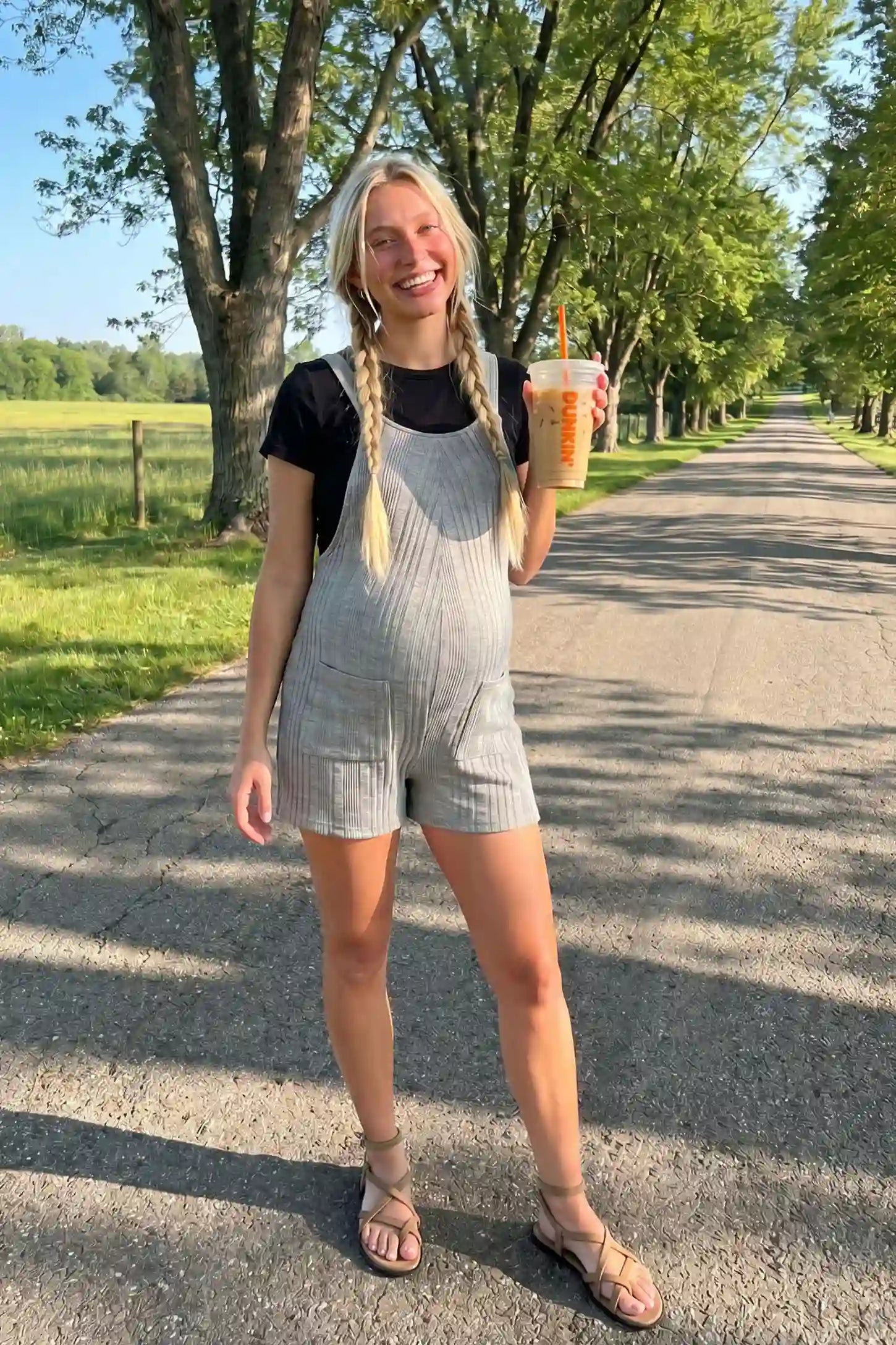 Ribbed Pocket Knit Maternity Romper Model wearing the gray Ribbed Pocket Knit Maternity Romper in an outdoor lifestyle setting.