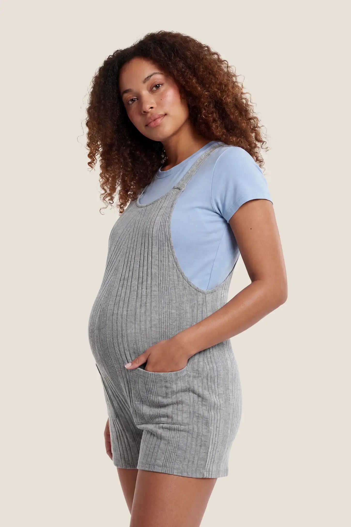 Ribbed Pocket Knit Maternity Romper Side view of the gray Ribbed Pocket Knit Maternity Romper designed to fit comfortably throughout pregnancy.