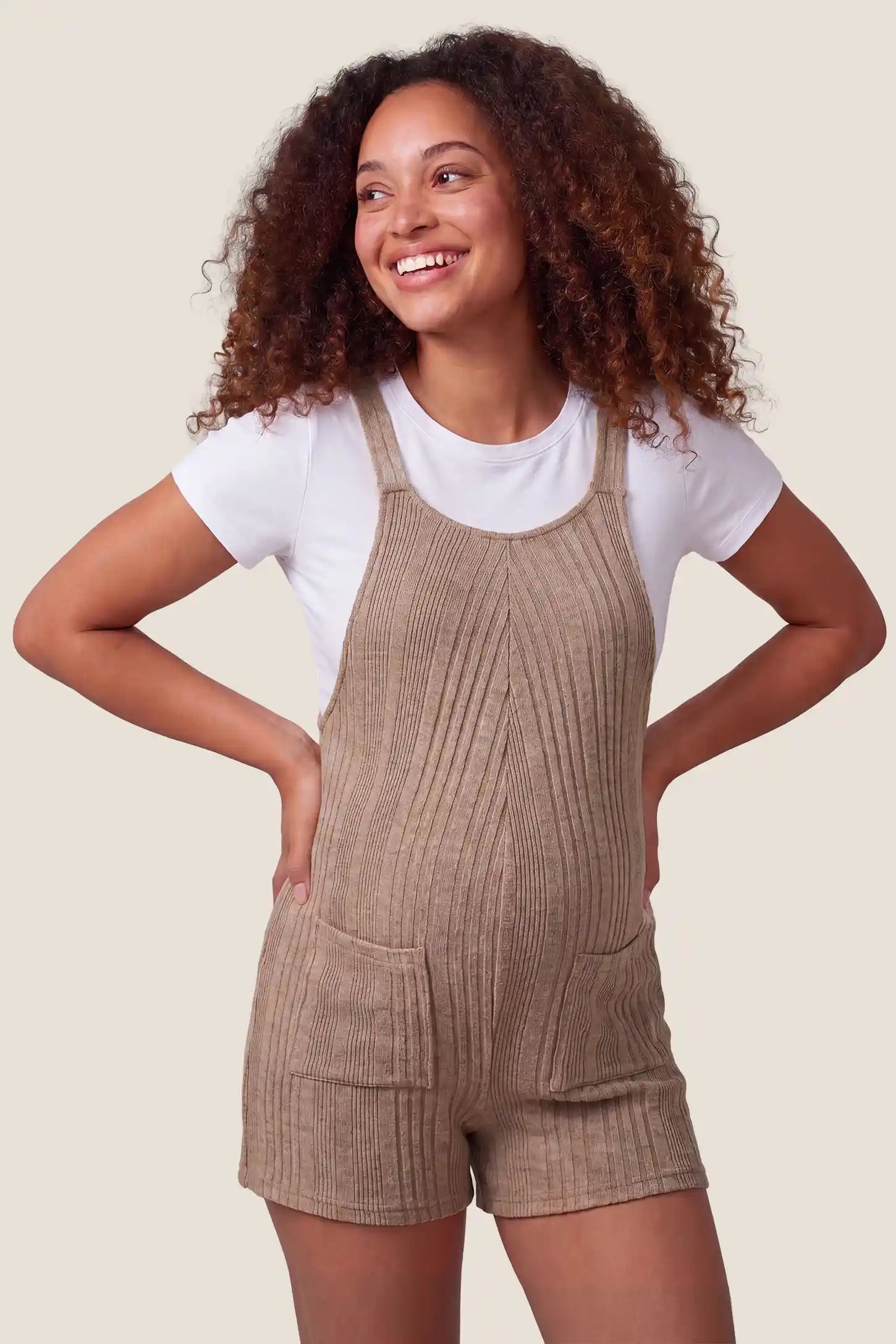 Ribbed Pocket Knit Maternity Romper Front view of the khaki Ribbed Pocket Knit Maternity Romper with front pockets and a soft knit feel.

