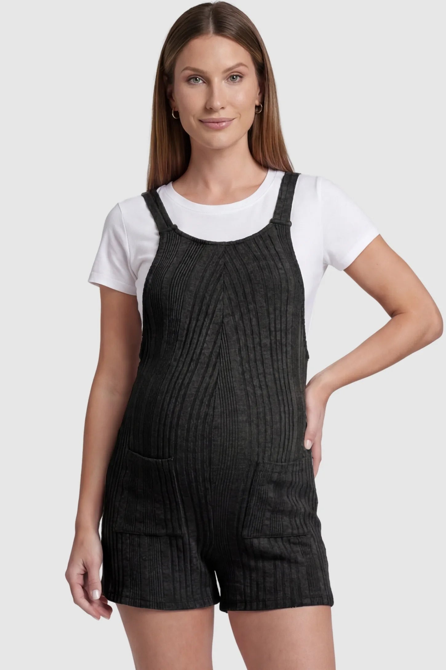 Ribbed Pocket Knit Romper in Black featuring a classic vertical ribbed texture on a pregnant model, front view.