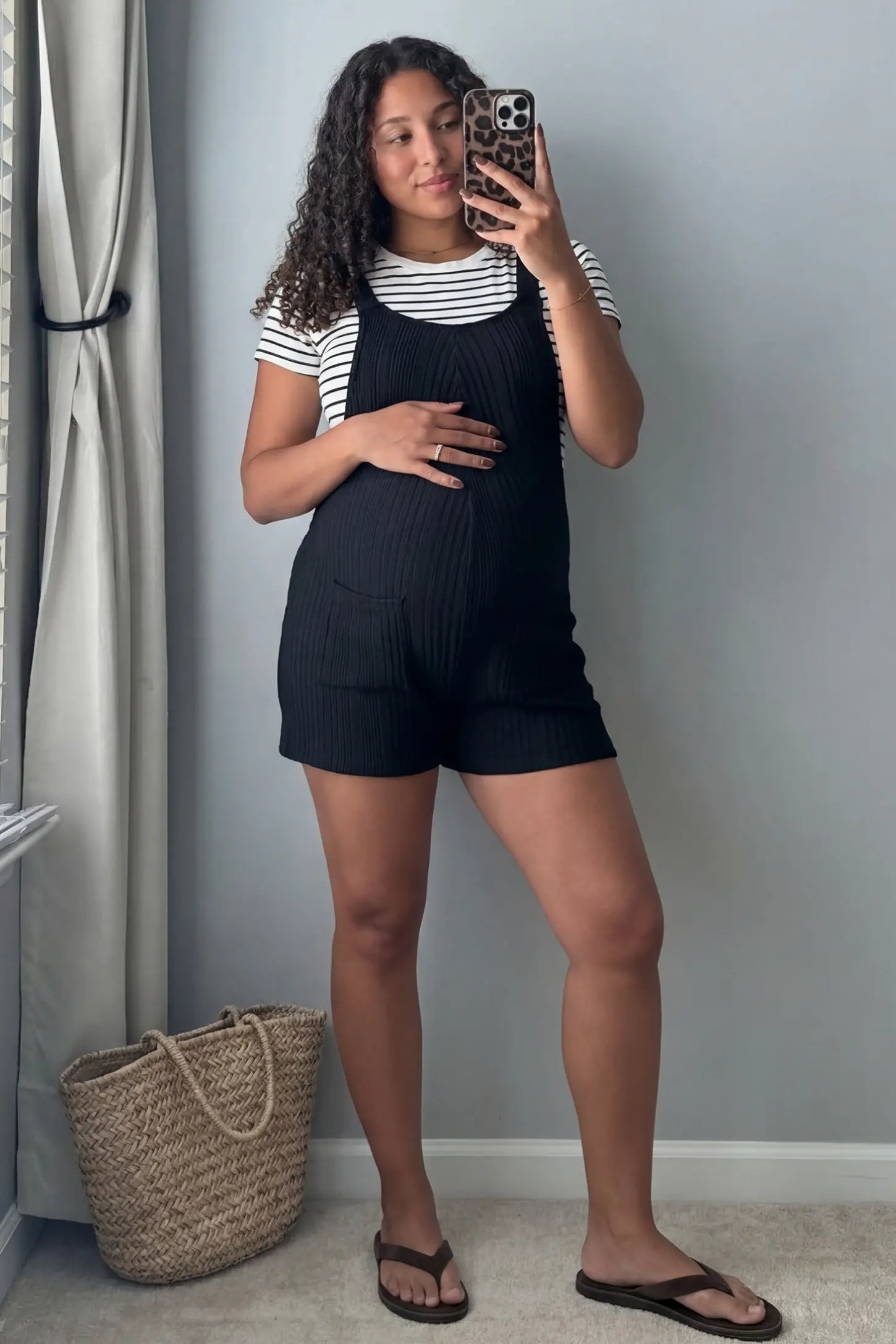 Ribbed Pocket Knit Maternity Romper Ribbed Pocket Knit Romper in Black featuring a soft ribbed finish on a pregnant model, mirror selfie view.