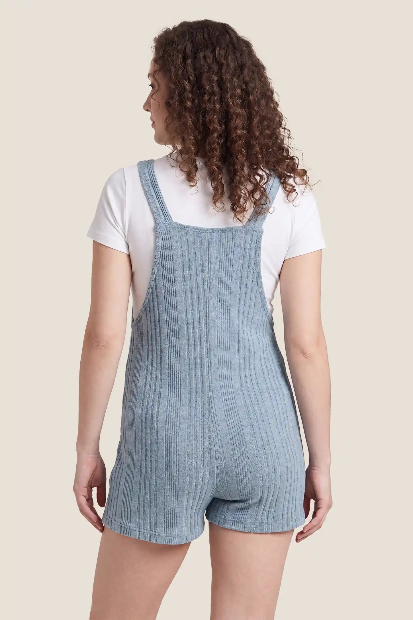 Ribbed Pocket Knit Maternity Romper Ribbed Pocket Knit Romper in Blue featuring an all-over ribbed pattern on a pregnant model, back view.

