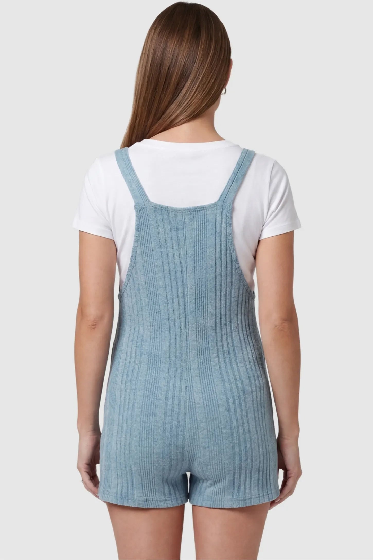 Ribbed Pocket Knit Maternity Romper Ribbed Pocket Knit Romper in Blue featuring an all-over ribbed pattern on a pregnant model, back view.