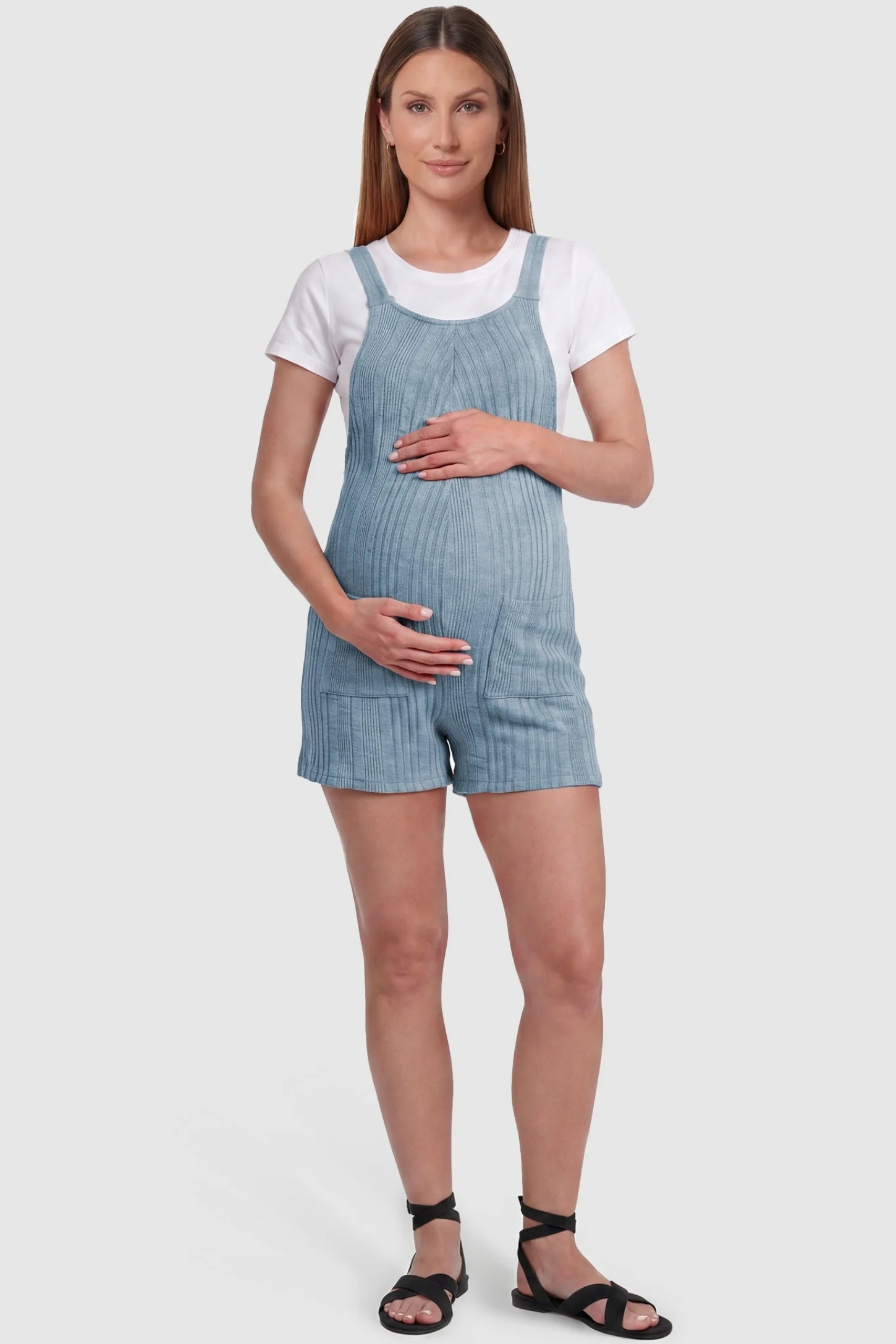 Ribbed Pocket Knit Maternity Romper Ribbed Pocket Knit Romper in Blue featuring a classic vertical ribbed texture on a pregnant model, front view.