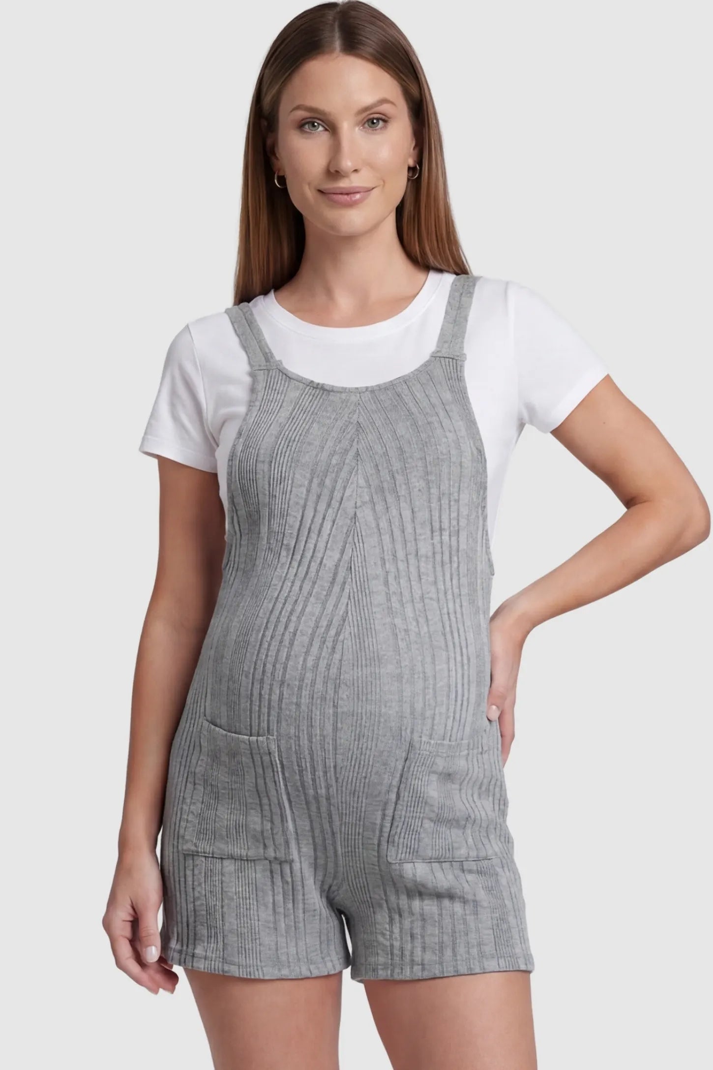 Ribbed Pocket Knit Maternity Romper Ribbed Pocket Knit Romper in Gray featuring a classic vertical ribbed texture on a pregnant model, front view.
