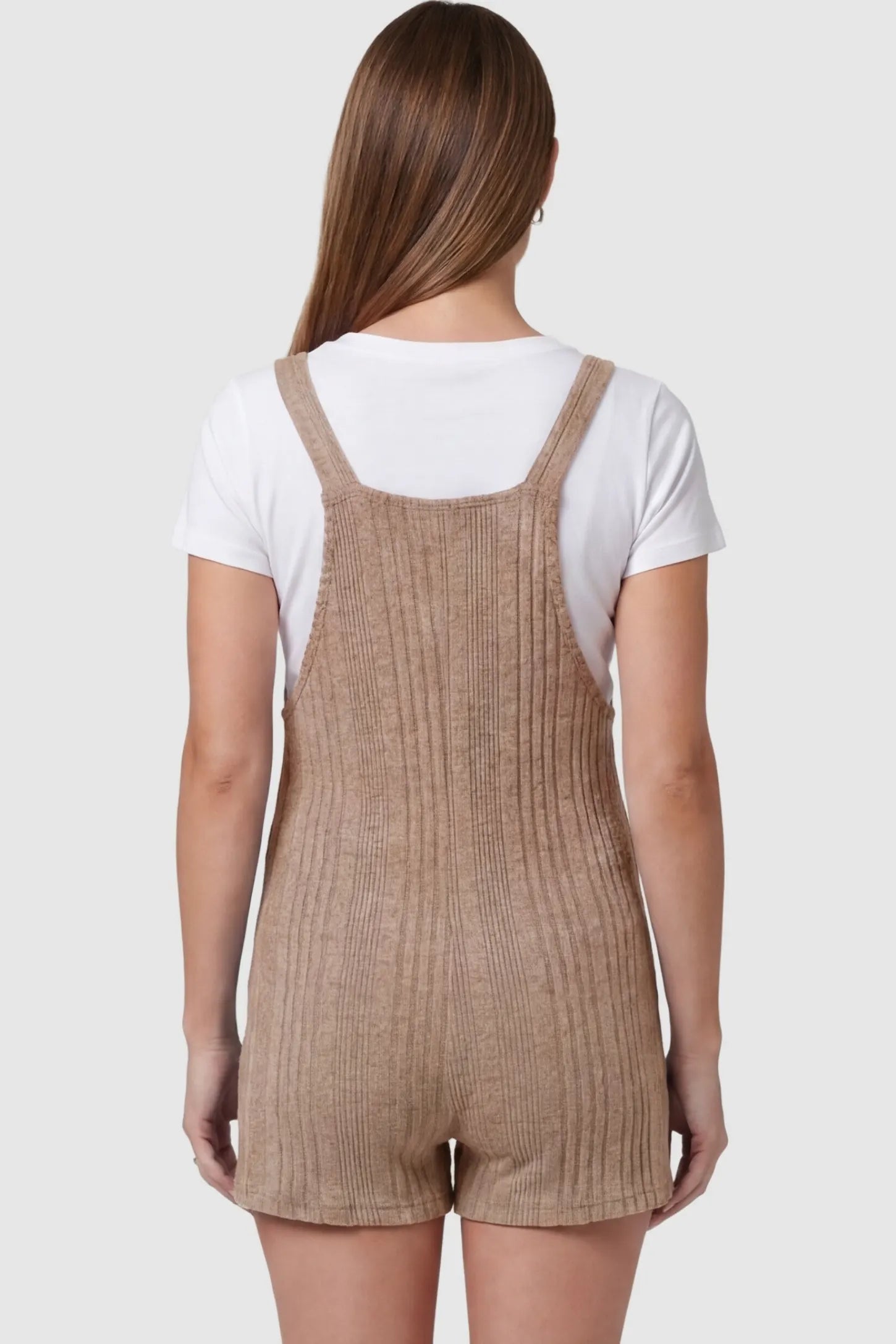 Ribbed Pocket Knit Maternity Romper Ribbed Pocket Knit Romper in Khaki featuring an all-over ribbed pattern on a pregnant model, back view.