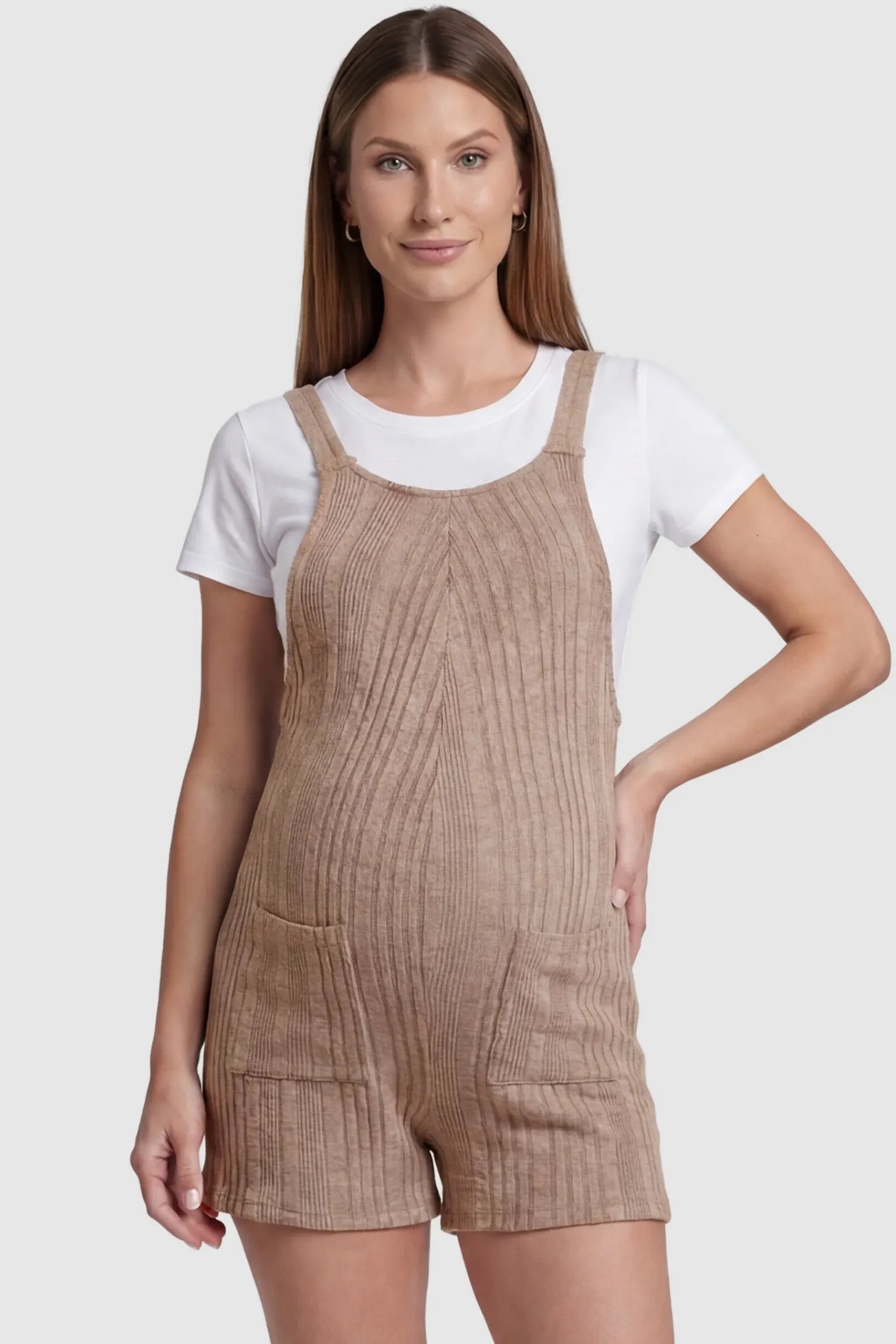 Ribbed Pocket Knit Maternity Romper Ribbed Pocket Knit Romper in Khaki featuring a classic vertical ribbed texture on a pregnant model, front view.
