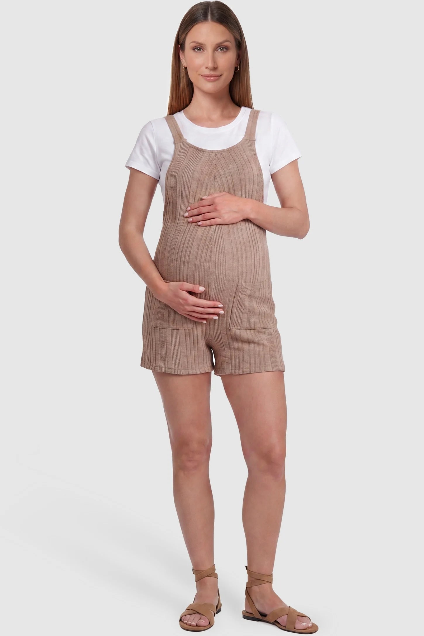 Ribbed Pocket Knit Maternity Romper Ribbed Pocket Knit Romper in Khaki featuring a classic vertical ribbed texture on a pregnant model, front view.