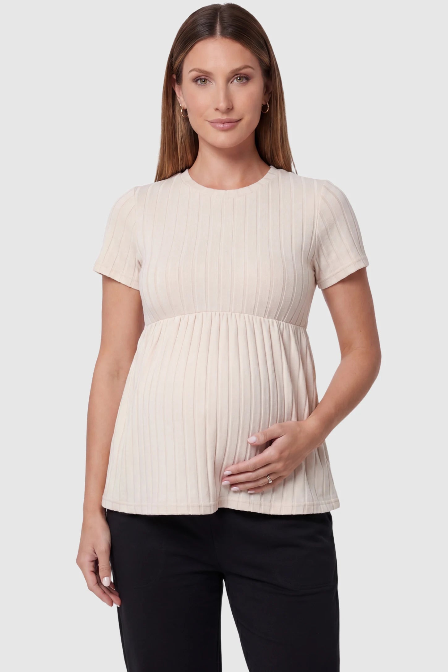 Ribbed Round Neck Short Sleeve Maternity Top Ribbed Round Neck Short Sleeve Maternity Top in Beige featuring a soft knit stretch and short sleeves on a pregnant model, front view.