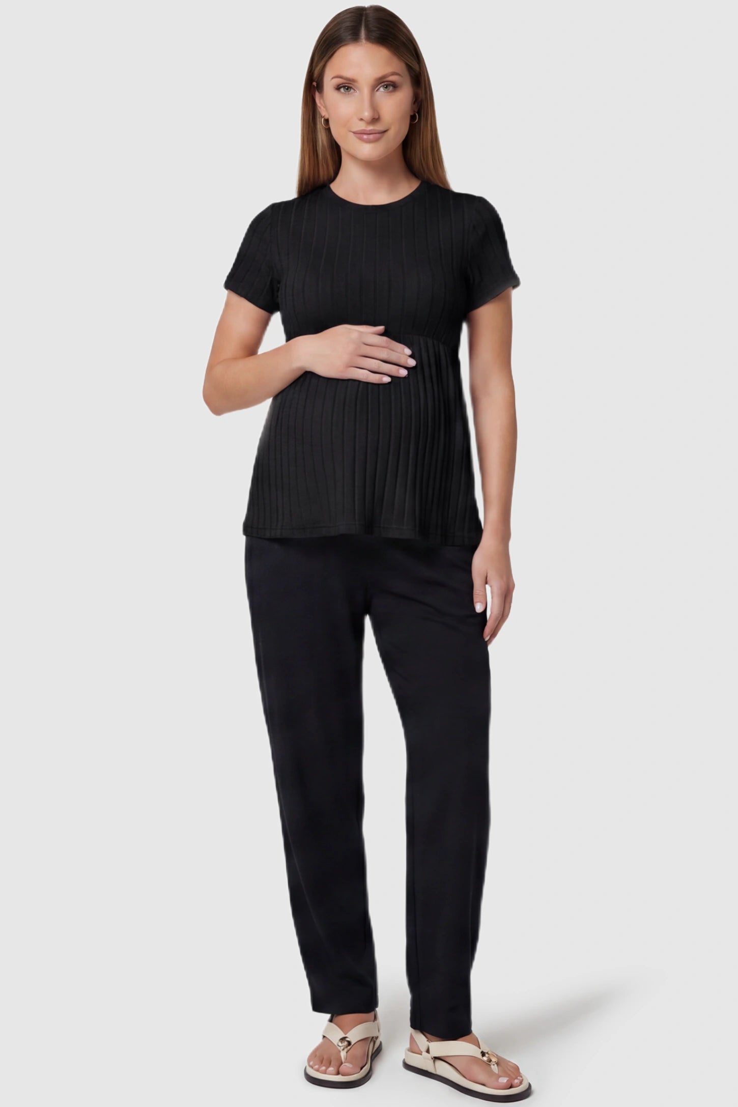 Ribbed Round Neck Short Sleeve Maternity Top Ribbed Round Neck Short Sleeve Maternity Top in Black featuring a soft knit stretch and short sleeves on a pregnant model, full body view.