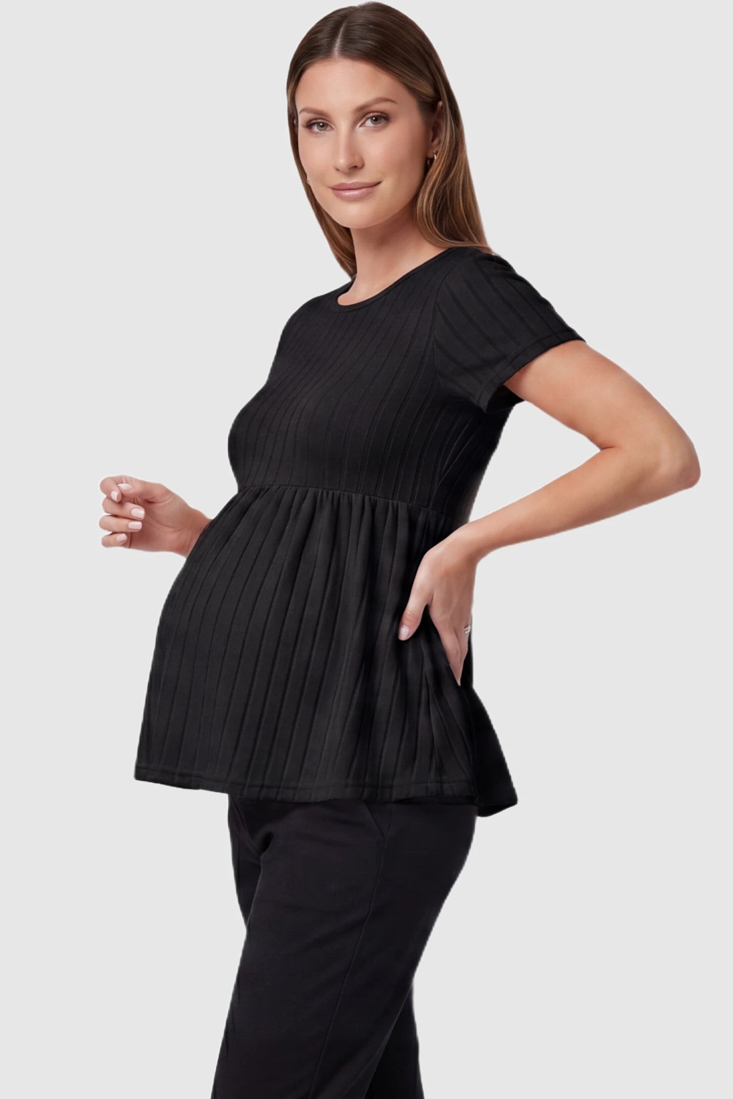 Ribbed Round Neck Short Sleeve Maternity Top in Black featuring a soft knit stretch and short sleeves on a pregnant model, side view.