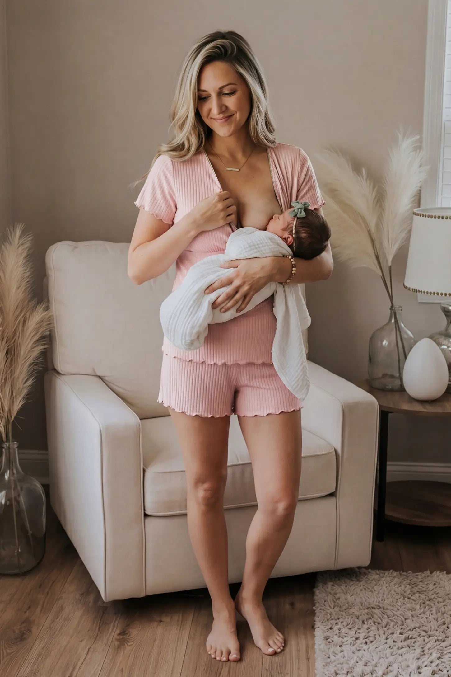 Ribbed Short Sleeve & Drawstring Shorts Maternity Pajama Set Ribbed Short Sleeve & Drawstring Shorts Maternity Pajama Set in Pink featuring soft fine-rib knit with clip-down nursing access on a postpartum model breastfeeding, lifestyle view.