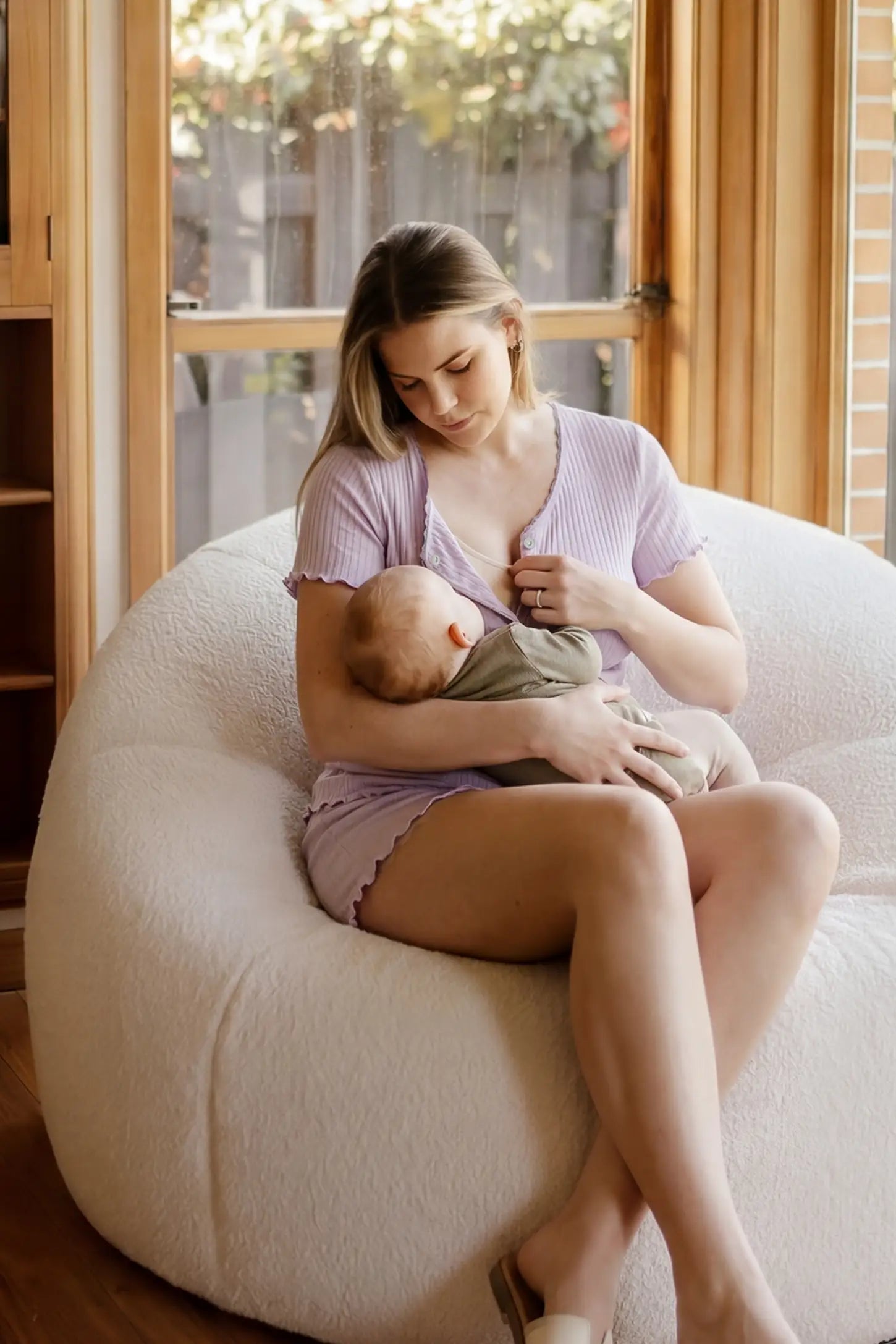 Ribbed Short Sleeve & Drawstring Shorts Maternity Pajama Set Ribbed Short Sleeve & Drawstring Shorts Maternity Pajama Set in Purple featuring soft fine-rib knit with clip-down nursing access on a postpartum model breastfeeding, lifestyle view.