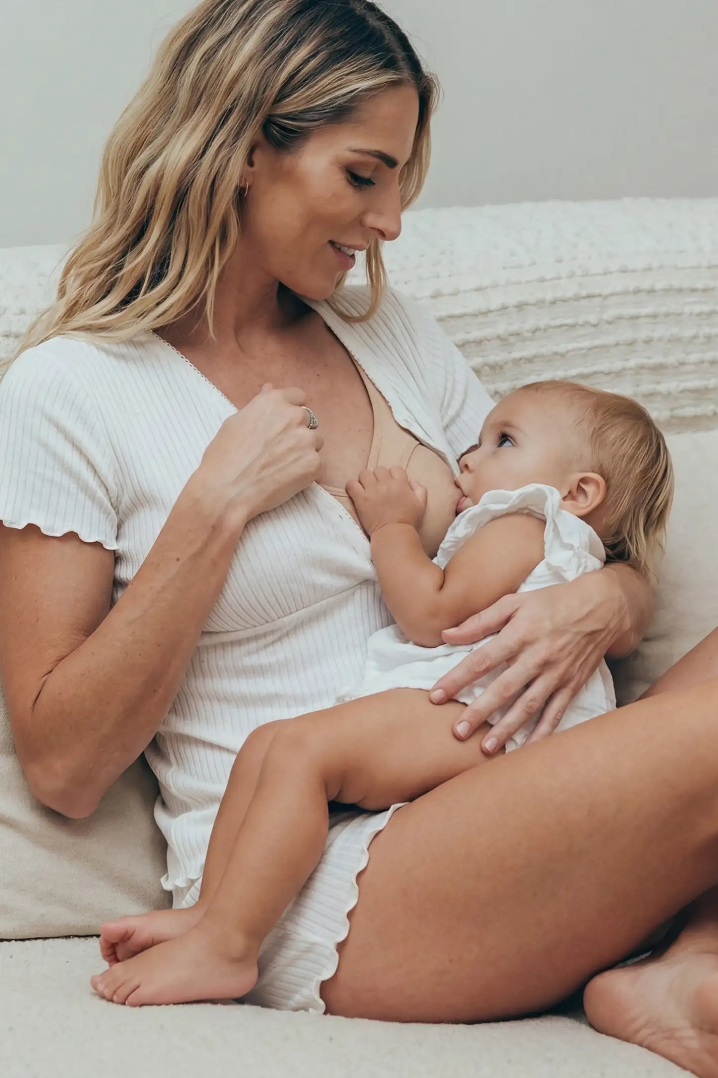 Ribbed Short Sleeve & Drawstring Shorts Maternity Pajama Set Ribbed Short Sleeve & Drawstring Shorts Maternity Pajama Set in White featuring soft fine-rib knit with clip-down nursing access on a postpartum model breastfeeding, lifestyle view.