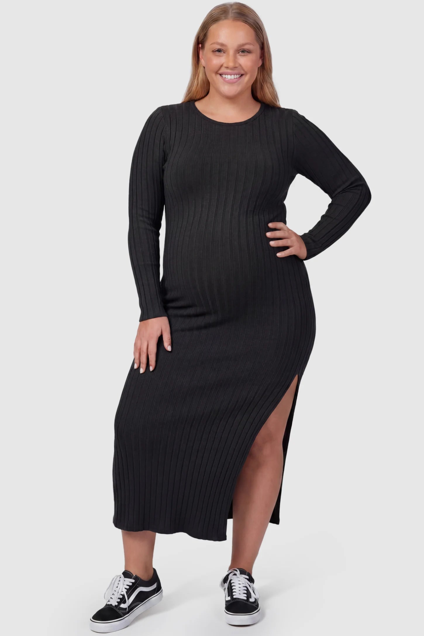 Ribbed Side Slit Fitted Long Sleeve Maternity Maxi Dress Ribbed Side Slit Fitted Long Sleeve Maternity Maxi Dress in Black featuring a high side slit on a plus size pregnant model, front view.