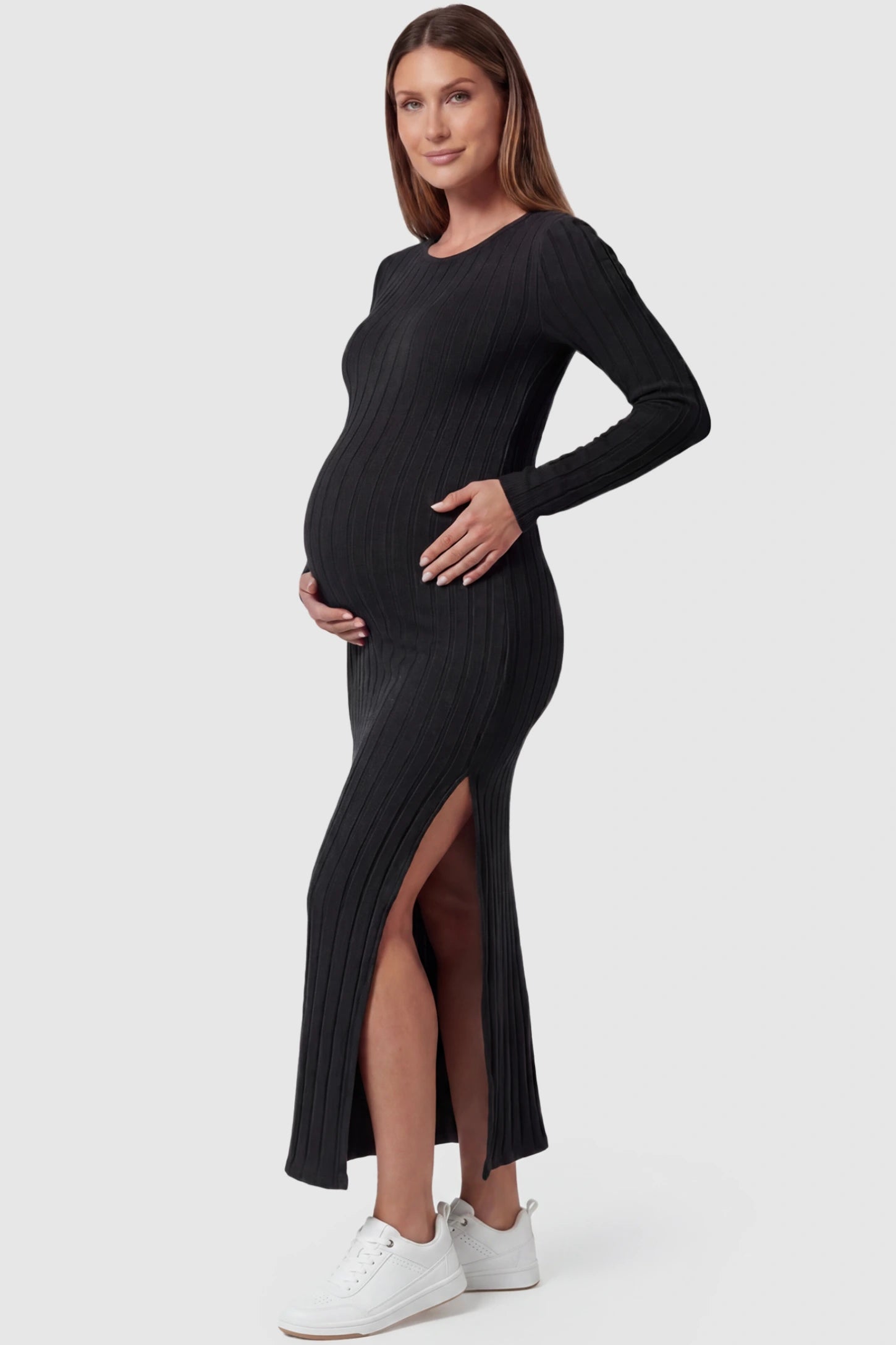 Ribbed Side Slit Fitted Long Sleeve Maternity Maxi Dress Ribbed Side Slit Fitted Long Sleeve Maternity Maxi Dress in Black featuring a high side slit on a pregnant model, side view.