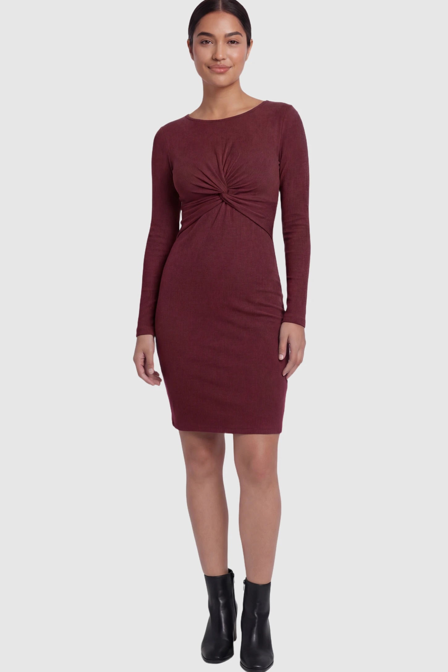 Ribbed Twist Front Long Sleeve Bodycon Maternity Short Dress Twist-Front Long Sleeve Ribbed Maternity Mini Dress in Red featuring a textured knit finish on a postpartum model showing front.