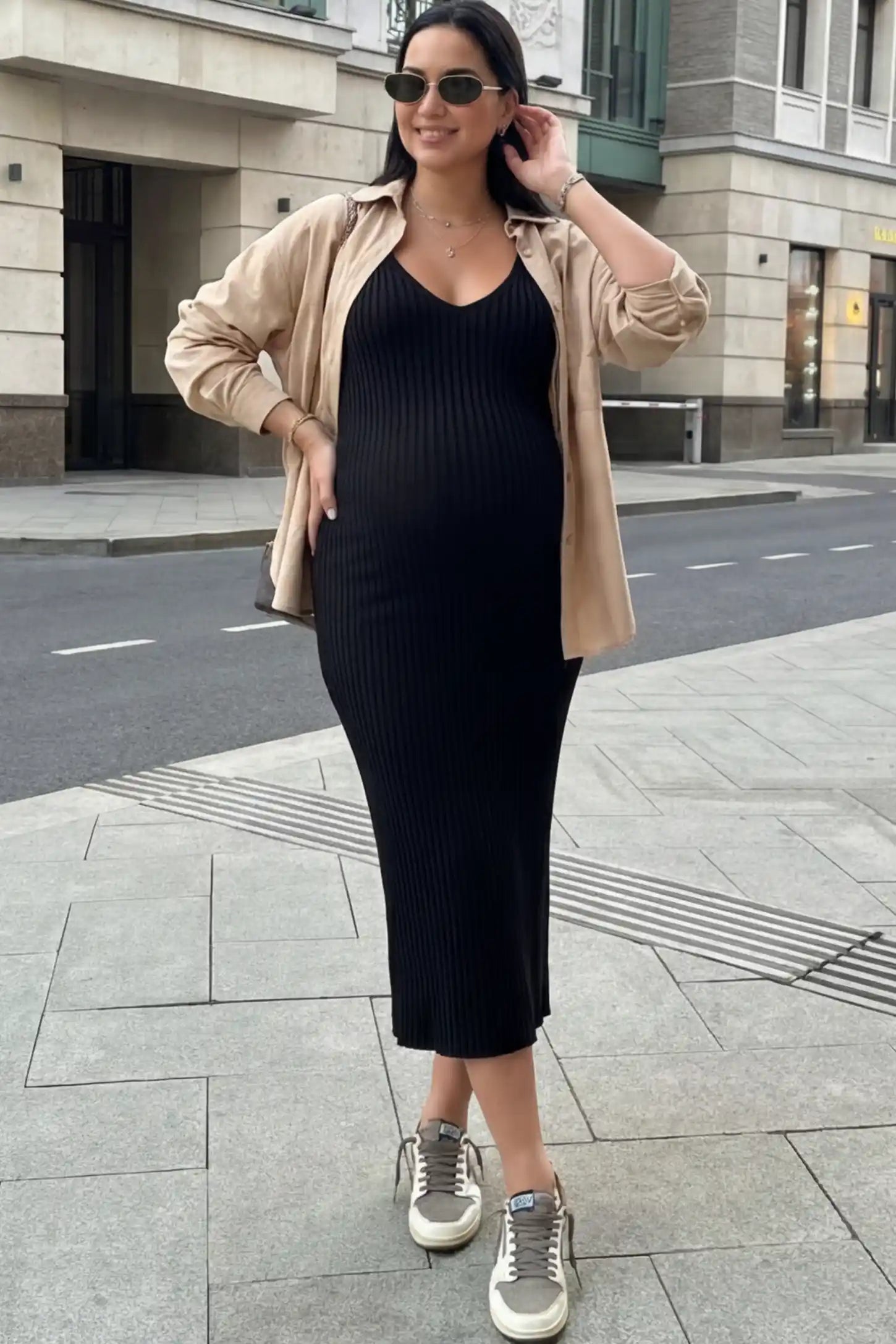 Ribbed V-Neck Maternity Midi Dress in Black featuring a fitted long sleeve on a pregnant model.