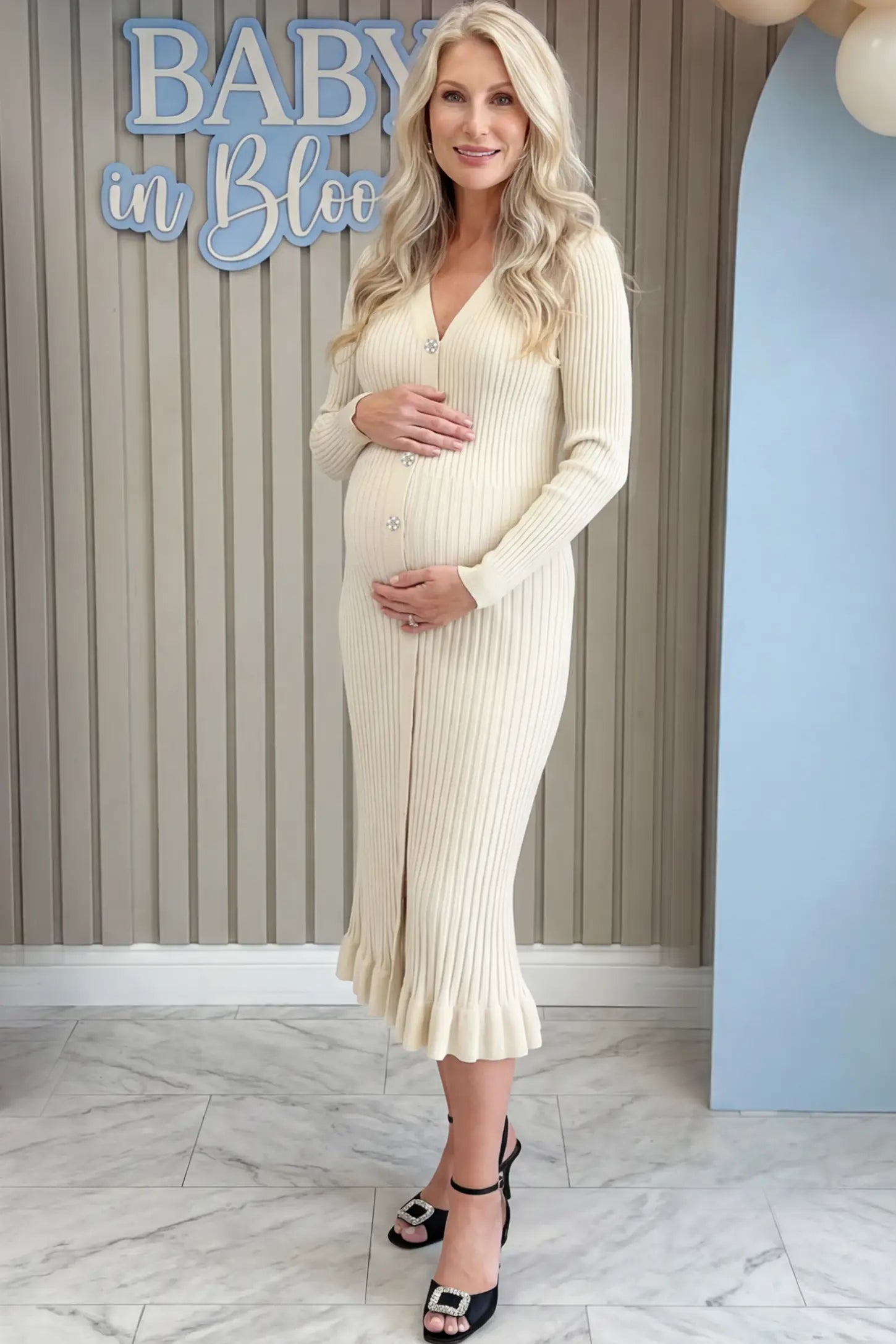 Ribbed V-Neck Maternity Midi Sweater Dress Ribbed V-Neck Maternity Midi Sweater Dress in White featuring rhinestone buttons on a pregnant woman showing front.