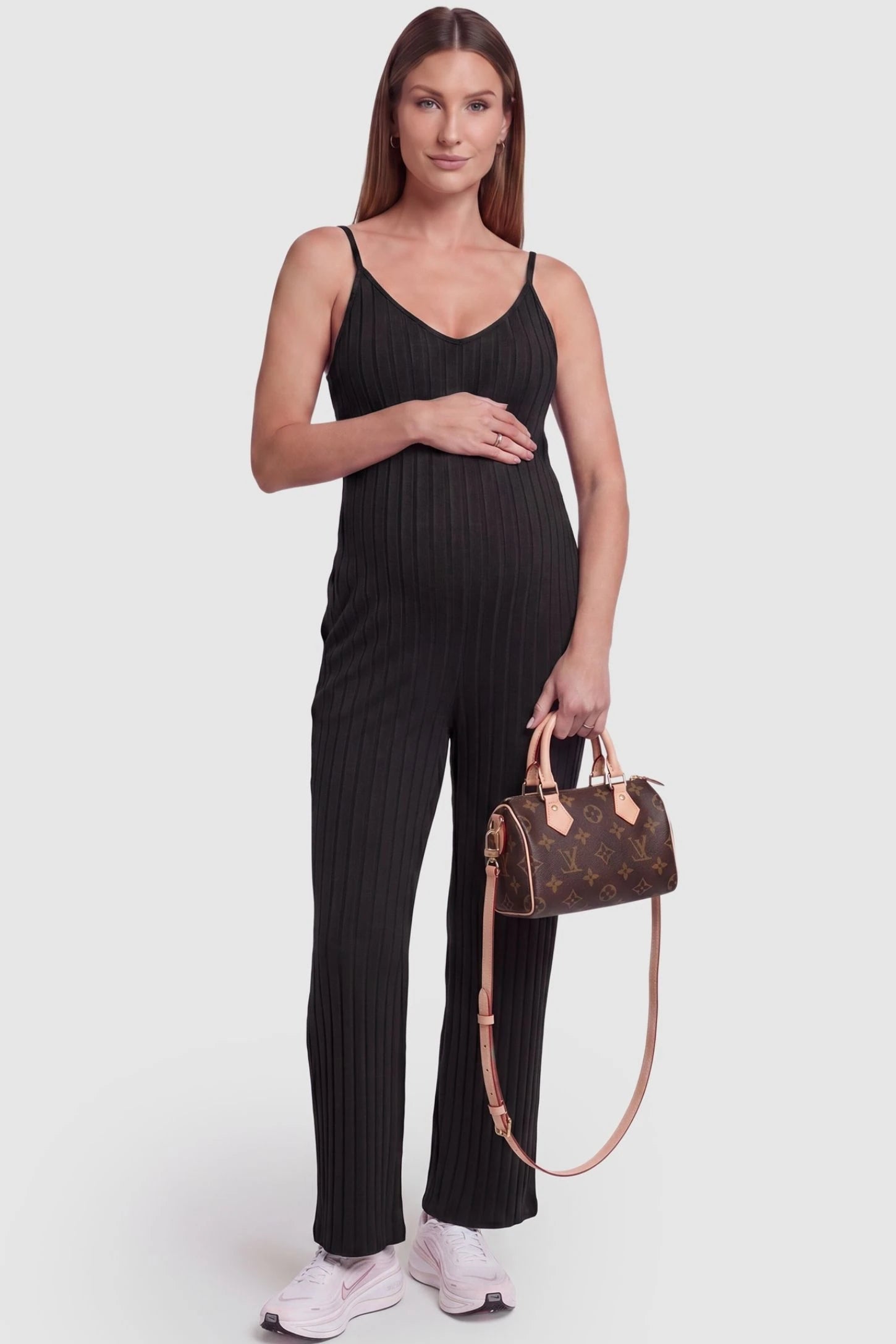 Ribbed Wide-Leg Maternity Camisole Jumpsuit Ribbed Wide-Leg Maternity Camisole Jumpsuit in Black featuring a vertical ribbed texture and relaxed wide leg on a pregnant model, front view.
