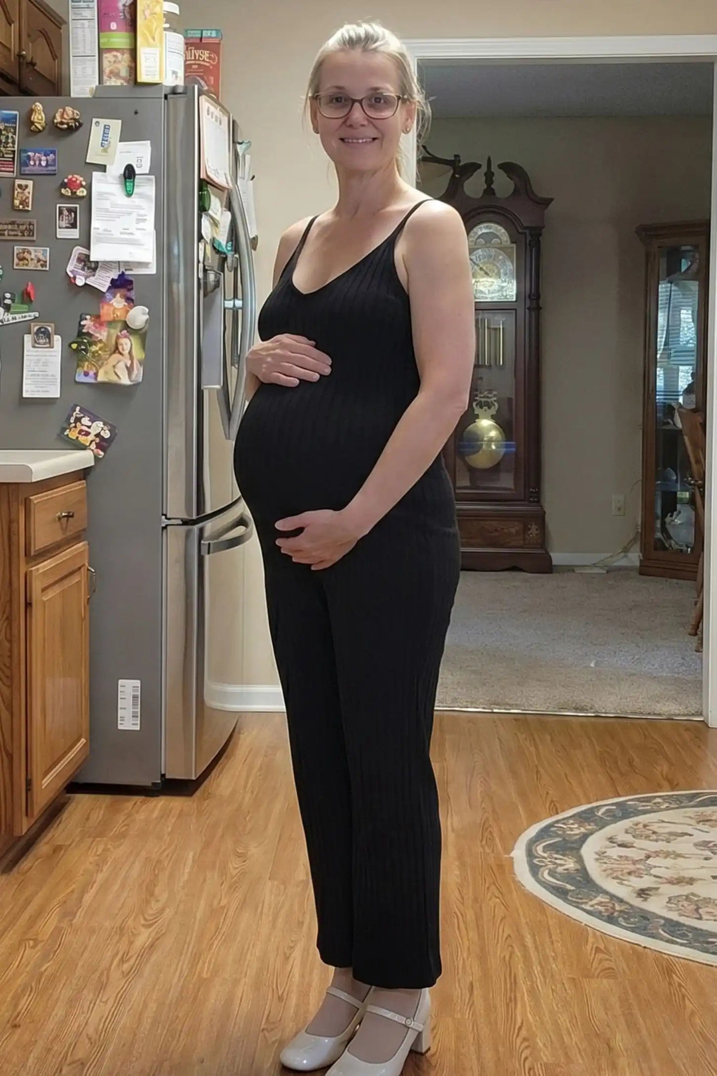 Ribbed Wide-Leg Maternity Camisole Jumpsuit Ribbed Wide-Leg Maternity Camisole Jumpsuit in Black featuring an effortless ribbed design and wide leg on a pregnant model, UGC view.