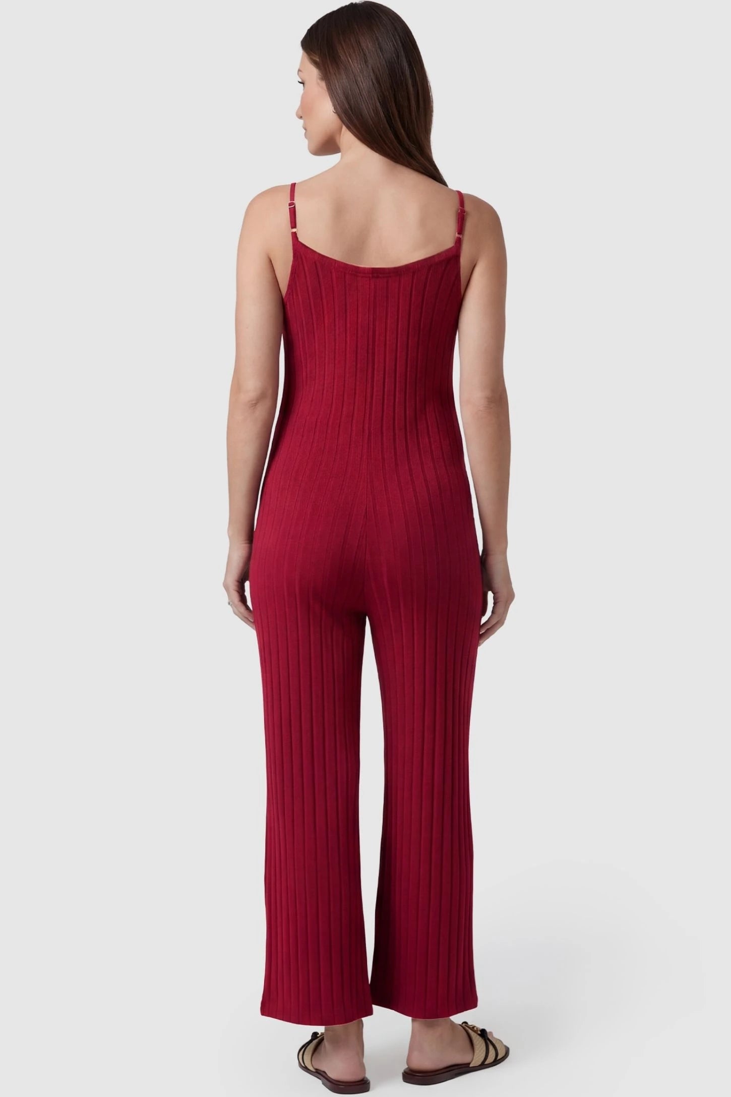 Ribbed Wide-Leg Maternity Camisole Jumpsuit Ribbed Wide-Leg Maternity Camisole Jumpsuit in Red featuring a high-stretch ribbed finish and wide-leg cut on a pregnant model, back view.