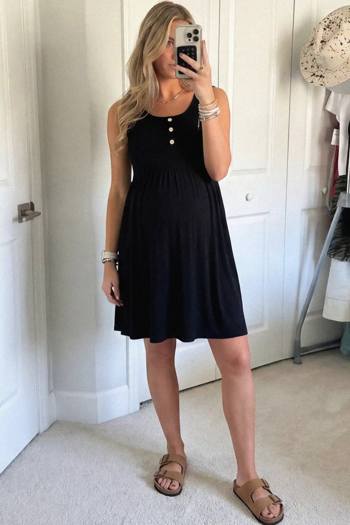 Round Neck Empire Waist Maternity Short Dress Round Neck Empire Waist Maternity Short Dress in Black featuring soft knit stretch on a pregnant woman in indoor setting, front view.