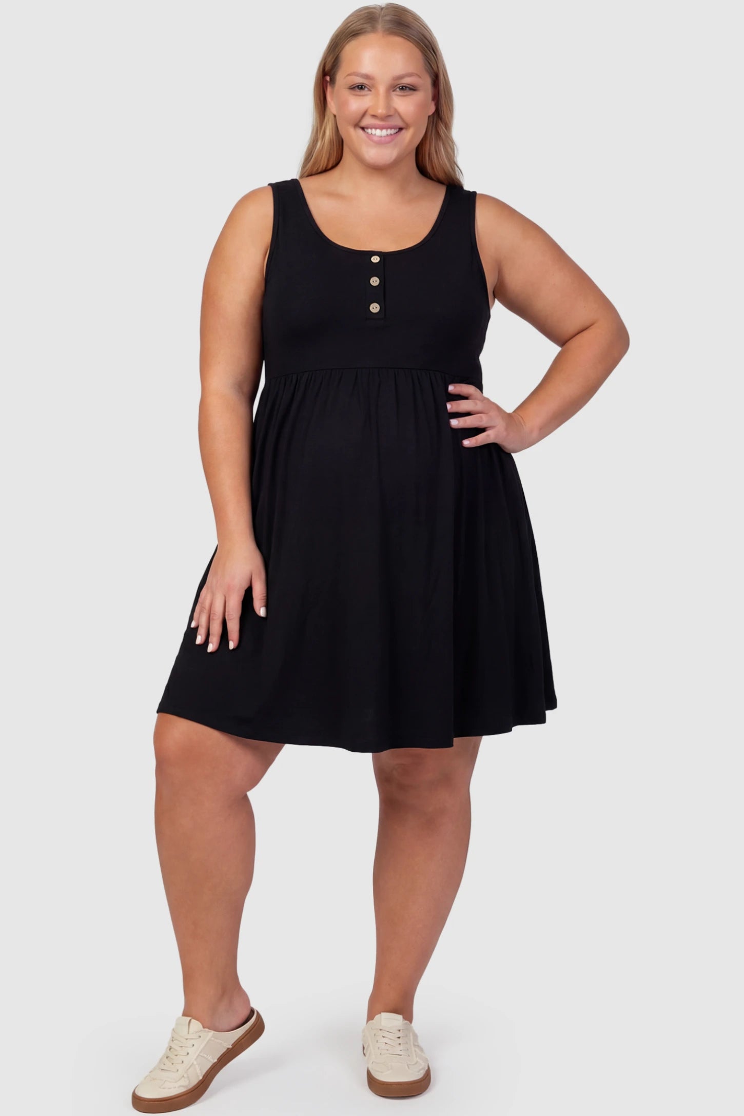 Round Neck Empire Waist Maternity Short Dress Round Neck Empire Waist Maternity Short Dress in Black featuring soft knit stretch on a plus size pregnant model, front view.