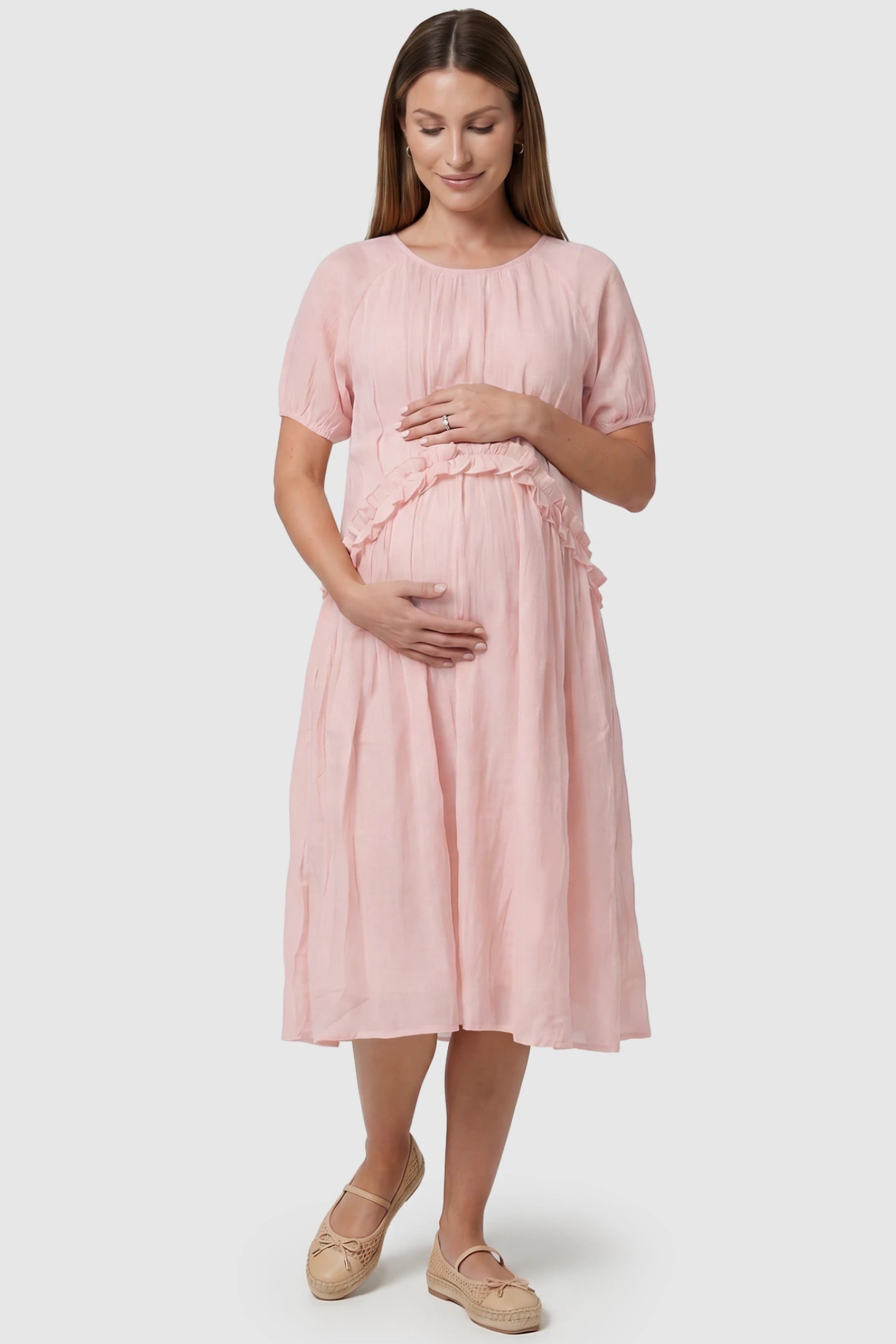 Round Neck Short Sleeve Flowy Maternity Midi Dress Round Neck Short Sleeve Flowy Maternity Midi Dress in Pink featuring ruffled waist on a pregnant model, front view.